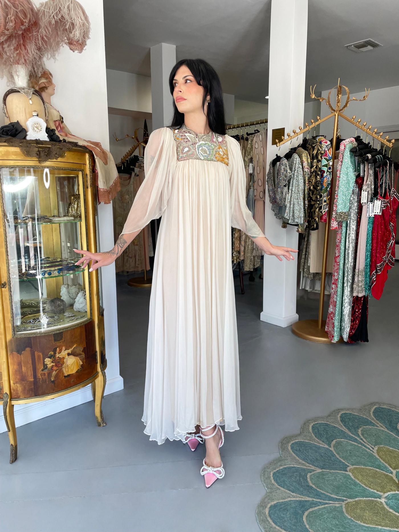 An unforgettable and incredibly rare Madame Grès haute couture ivory silk goddess bridal gown dating back to her 1968 spring/summer collection.  A very similar version was photographed on Twiggy for British Vogue magazine. This ethereal look was