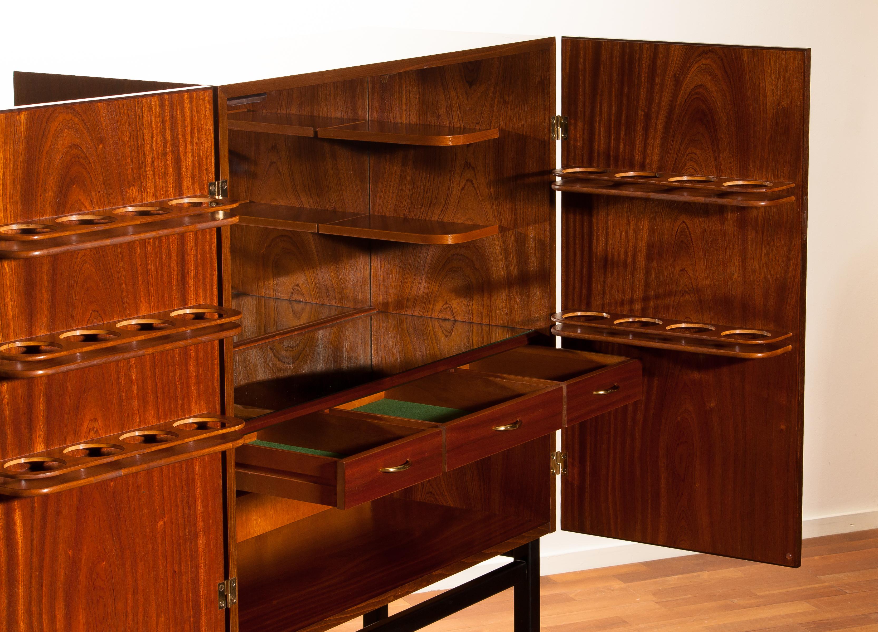 Extremely beautiful and unique dry bar/cocktail cabinet. The cabinet is made of mahogany inside and outside. This high-quality cabinet is made by Förenade Möbelfabrikerna Linköping and dated/ labeled/signed 4 May 1968.
Inside the dry bar cabinet,