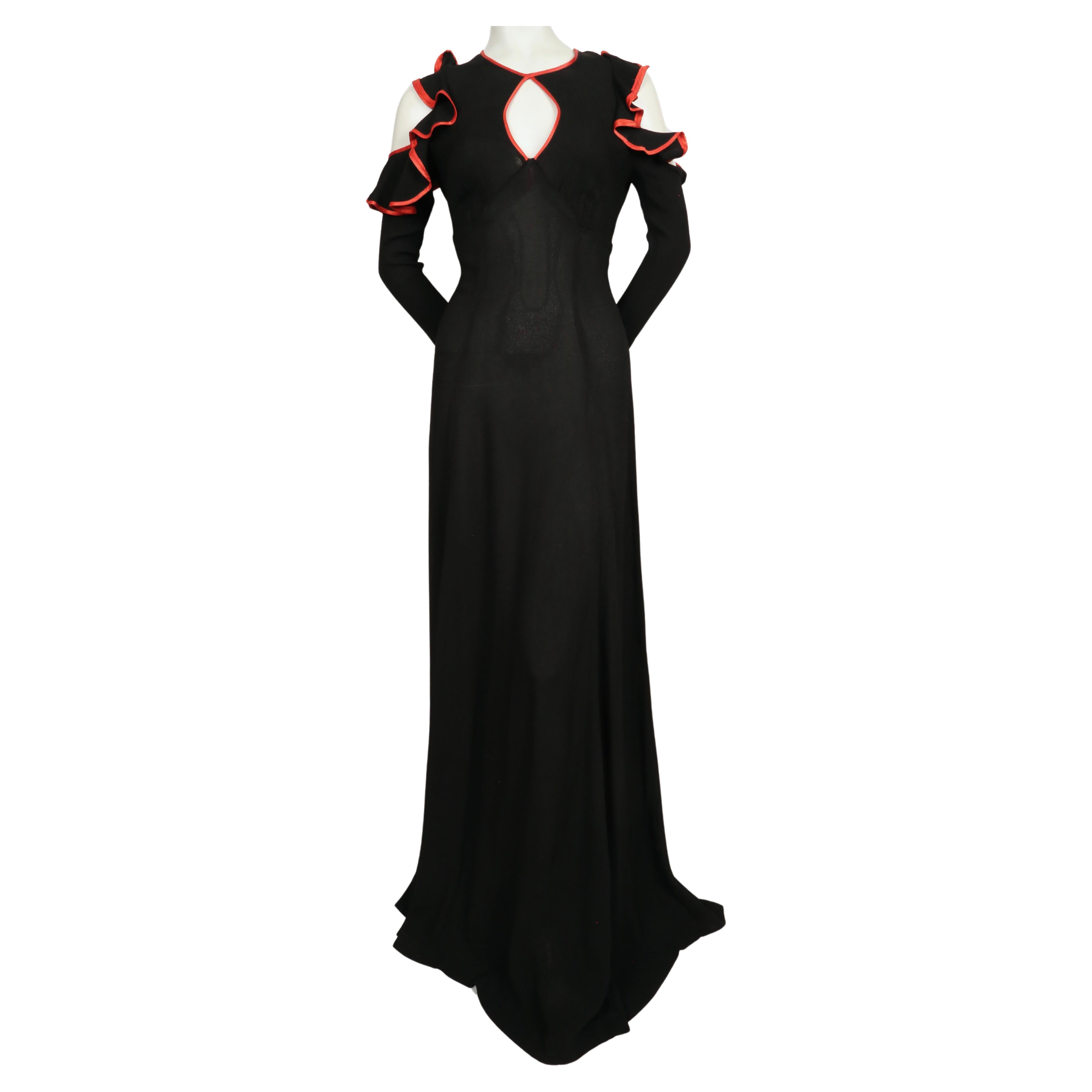 Jet-black, moss crepe, maxi dress with cut-out shoulders keyhole neckline, ruffles and red satin trim designed by Ossie Clark for Radley dating to 1968. Dress size is not marked, although it fits a US 2. Measurements are somewhat difficult to take