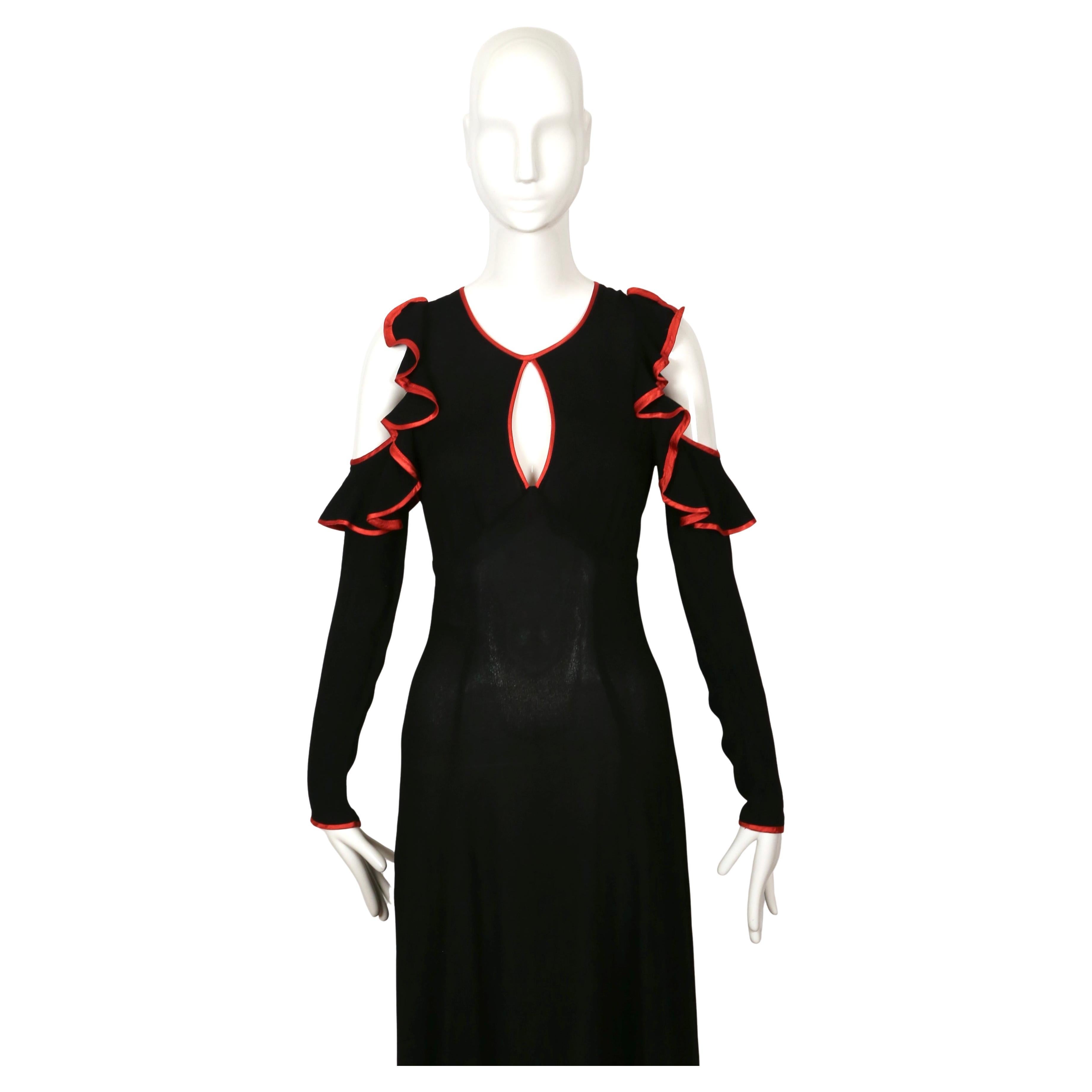 Jet-black, moss crepe, maxi dress with cut-out shoulders keyhole neckline, ruffles and red satin trim designed by Ossie Clark for Radley dating to 1968. Dress size is not marked, although it fits a US 2. Measurements are somewhat difficult to take