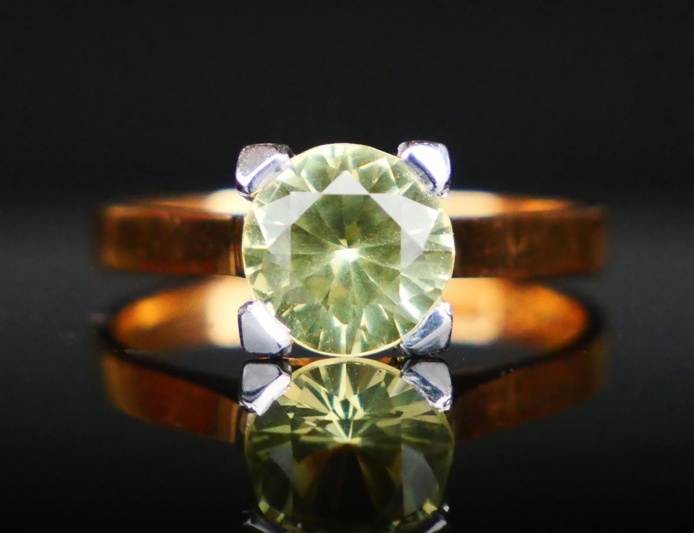 A Ring with claw set natural Yellow with strong tint of Green Sapphire diamond cut Ø7.5 mm x 5.5 mm  deep / ca. 2.5 ct. 
This stone may seem Yellow or Yellow - Green depending on light conditions. 18K Gold is Yellow with tint of Orange, claws in 18K