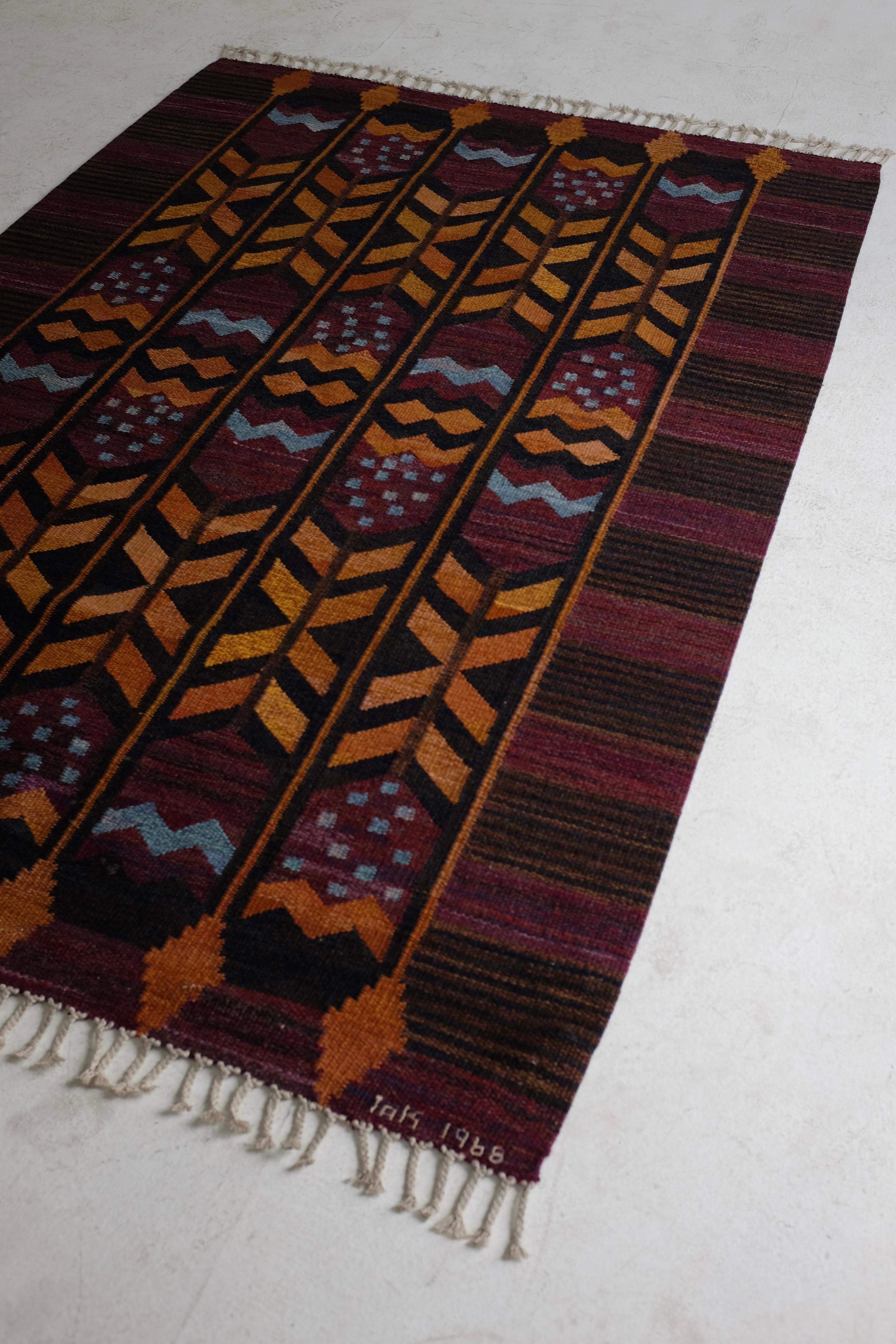 Stunning Vintage Swedish rug made in 1968 by Stockholm Läns Hemslöjdsförening. Made in vibrant purple, blue, orange and brown shades with new fringes. Made with tapestry technique this rug would also make a beautiful wall hanging. In a good used