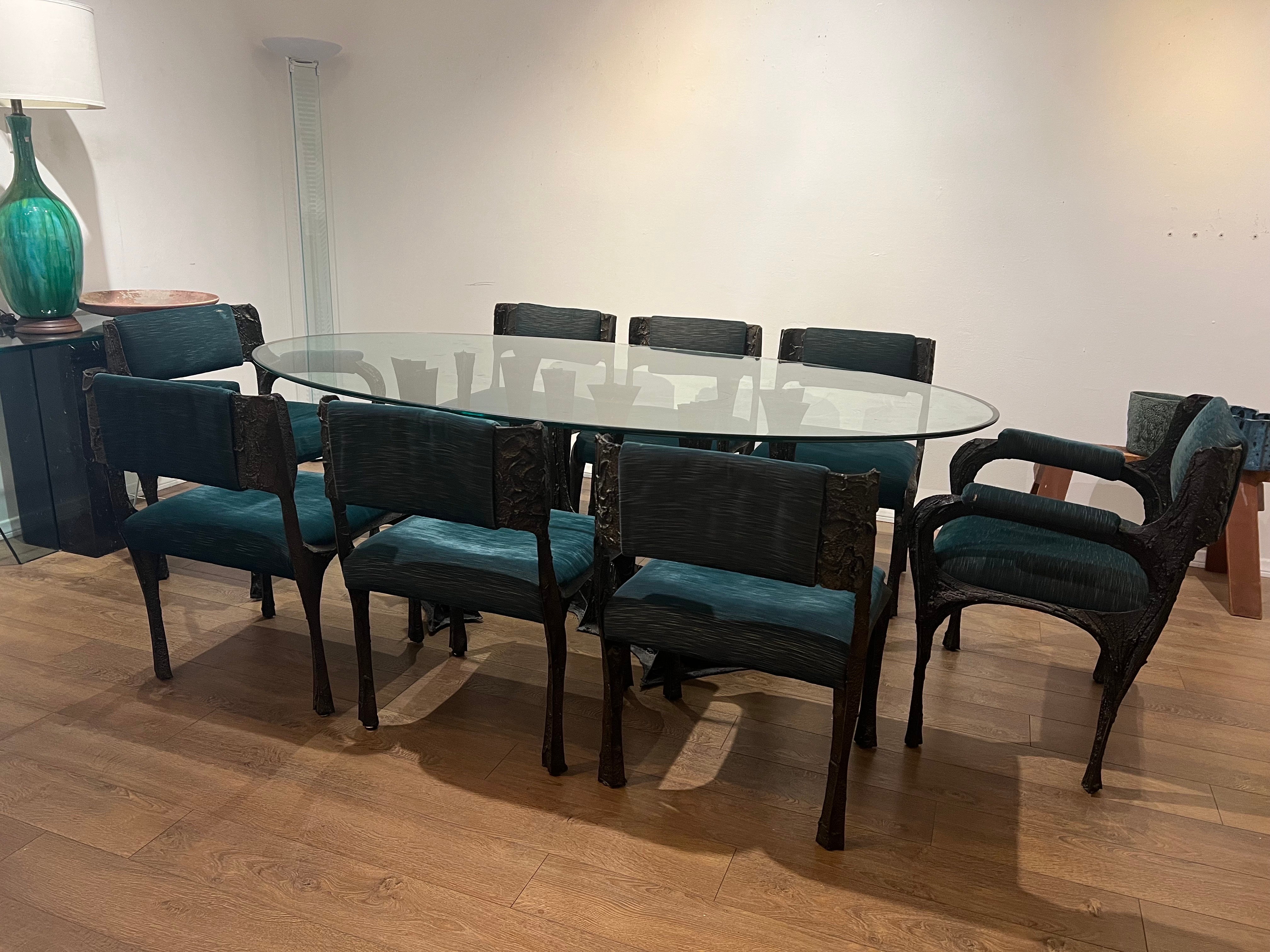 
Elevate your dining experience with this extraordinary set crafted by the legendary Paul Evans Studio in 1969. Comprising a rare ensemble of eight chairs and a dining table, this collection exemplifies the pinnacle of Brutalist design, showcasing