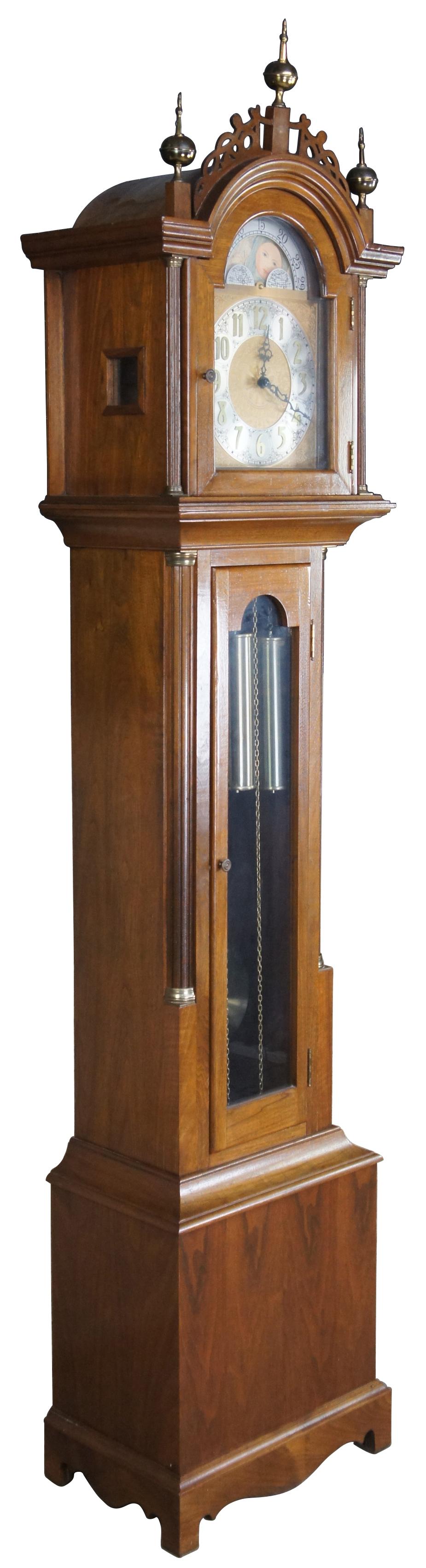 Handcrafted grandfather clock built by Jeff Sutton in 1969. Made from walnut in Georgian styling with fretwork crown, brass finials and peakaboo windows along the side of case. Includes modern works with sun and moon dial

Measures: 20.5