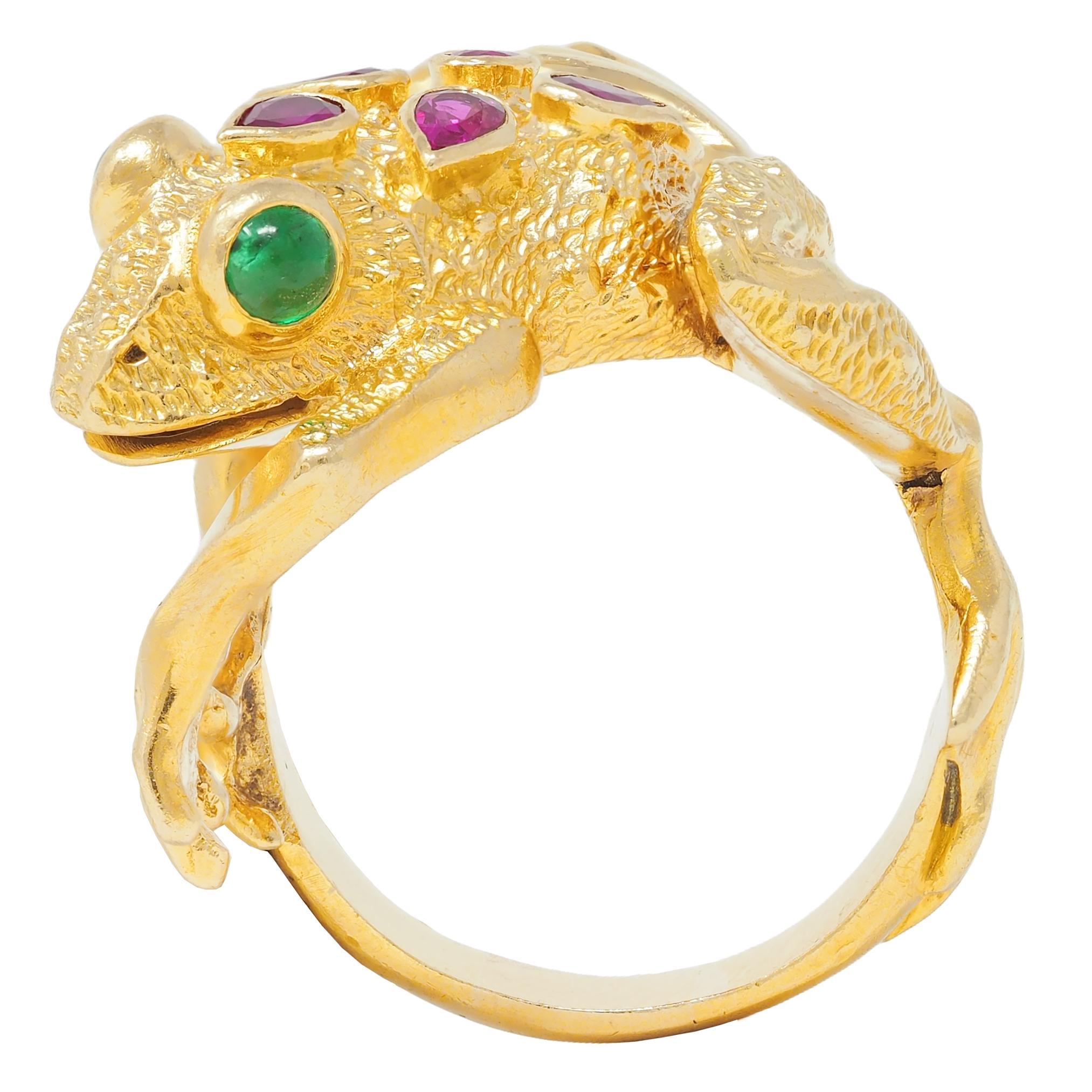 Designed as a dimensional gold frog with grooved features and depicted climbing 
Accented by organically stippled texture skin and rubies bezel set down back
Pear cut and transparent medium red - weighing approximately 1.20 carats total 
With bezel