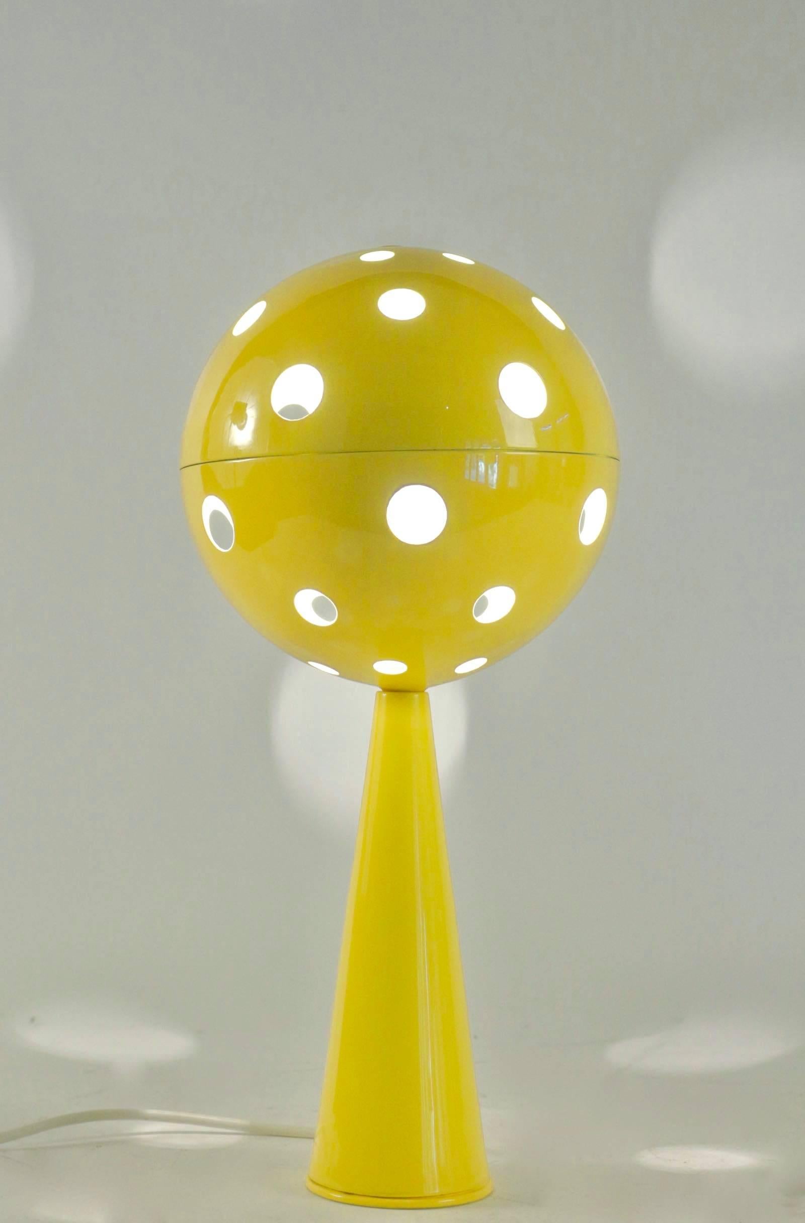 Rare table lamp model Planétaire / Planetary by Sabine Charoy.

Yellow lacquered steel. The conical foot lamp supports a large perforated ball which contains the bulb. The light shines through the holes of diffentes sizes.

The lamps was