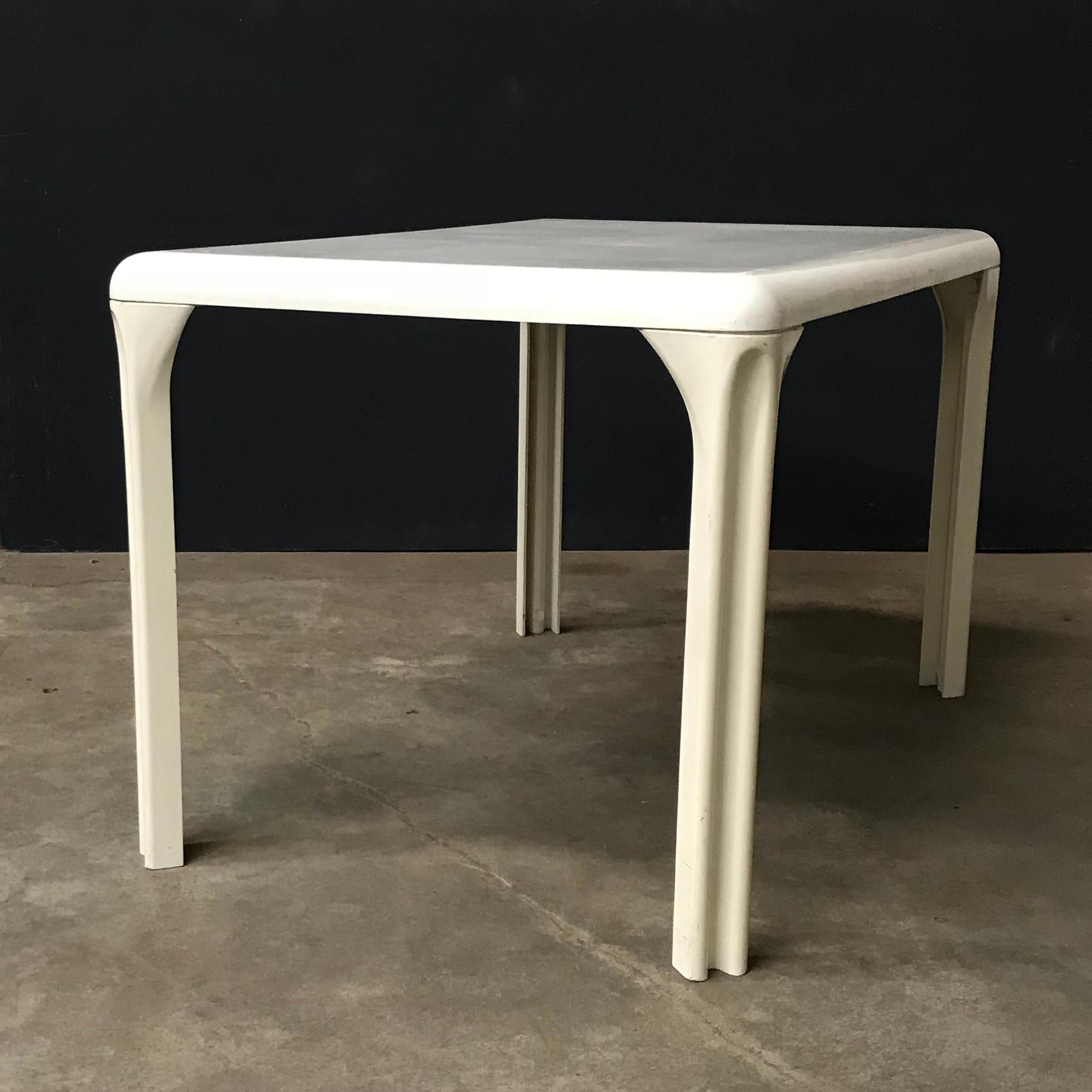 Magistretti table in white plastic. The table shows traces of wear like scratches, superficial (like picture #9 - #12 ) and deeper (#13 and #14) , spots and some loss of color/coating. The table top and legs show some change of color over the years.