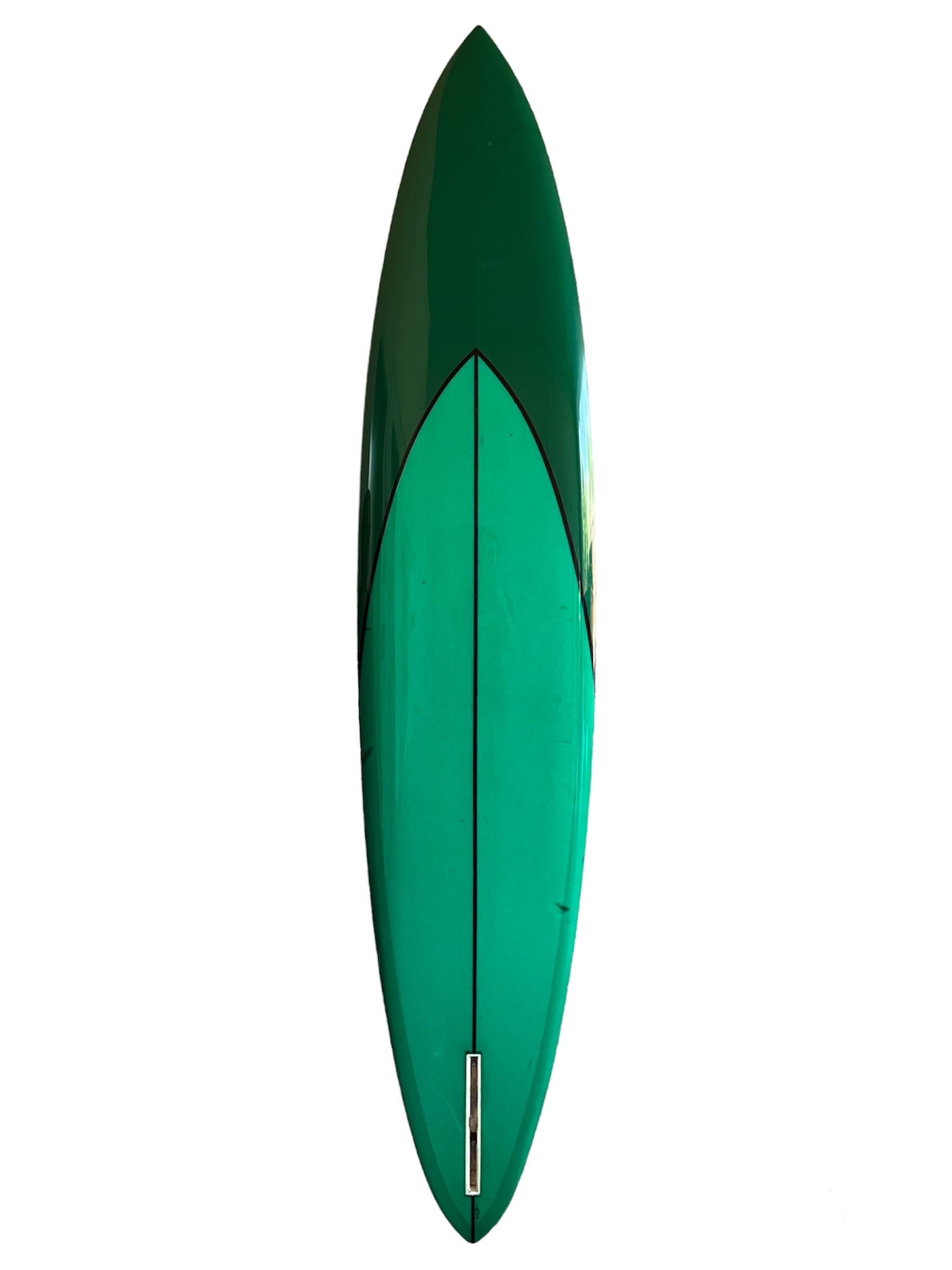 1969 Vintage Greg Noll Ben Aipa Surf Center Hawaii transitional era surfboard. Shaped by the late Ben Aipa (1942-2021). Features beautiful tint of sea foam green complimented by dark green accents with black pinstriping. Classoc transitional era