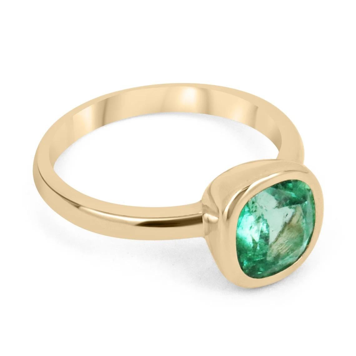 This ring is not for the faint of heart! Displayed is a medium Colombian emerald solitaire cushion-cut engagement/right-hand ring in 14K yellow gold. This gorgeous solitaire ring carries a full 1.96-carat emerald in a golden bezel setting. The
