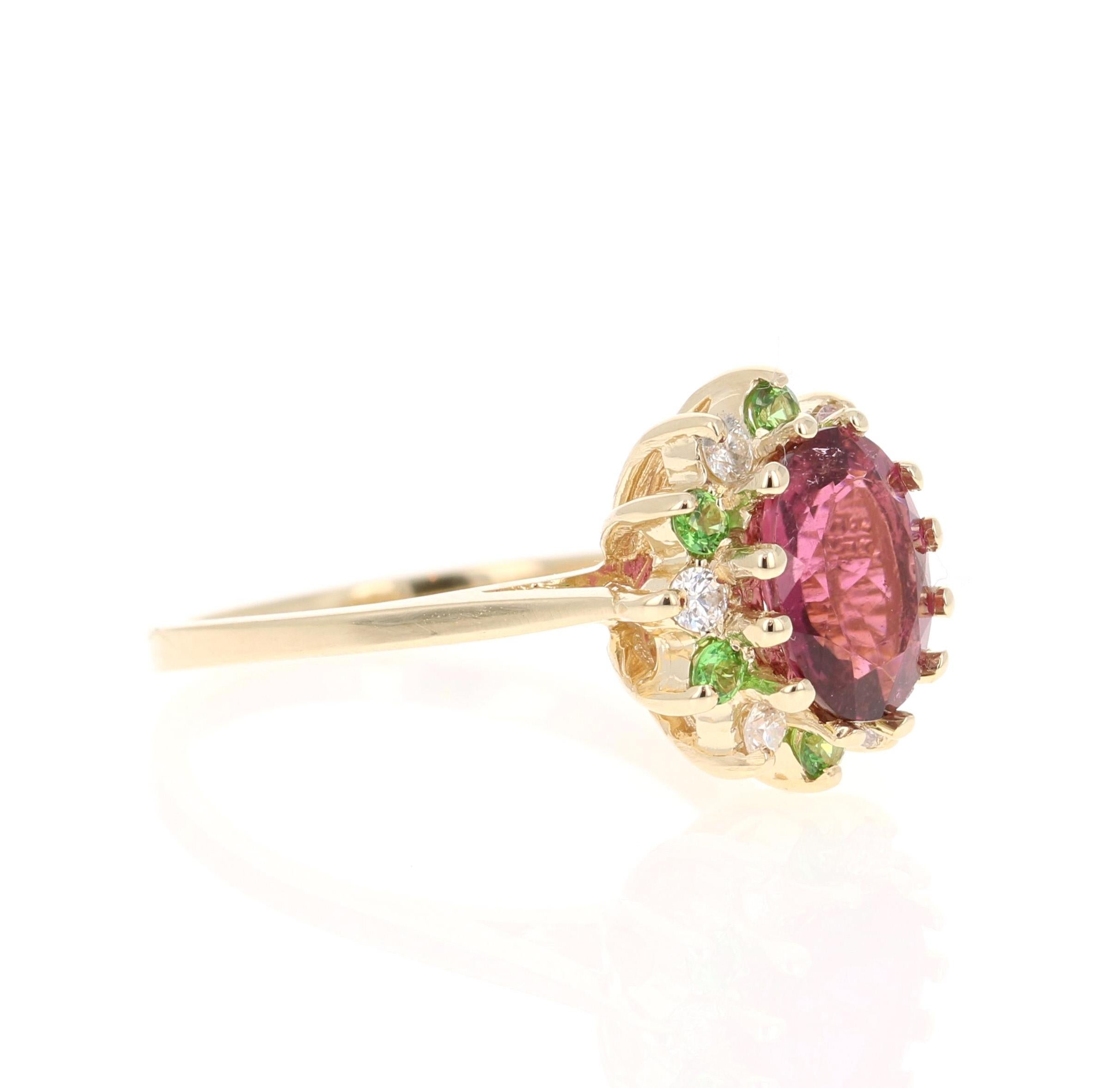 This ring has a gorgeous Oval Cut Pink Tourmaline that weighs 1.59 Carats. Floating around the tourmaline is a unique halo of Tsavorites that weigh 0.20 Carats and 6 Round Cut Diamonds that weigh 0.18 Carats. (Clarity: SI, Color: F) The total carat