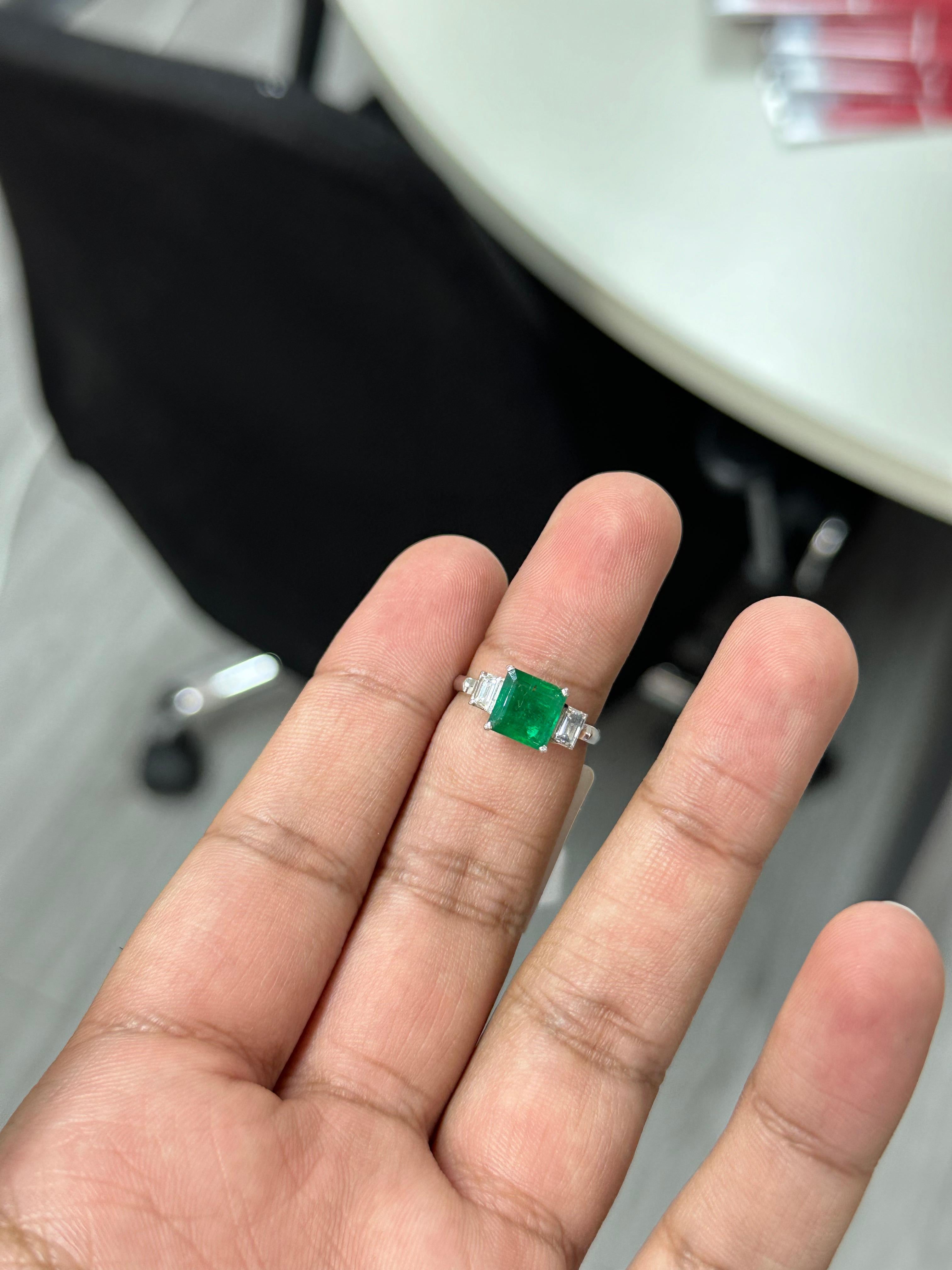 Introducing the epitome of luxury and sophistication, behold the breathtaking three-stone, Emerald and Diamond Ring, a true marvel in the world of fine jewelry. Crafted with precision and passion, this extravagant piece exudes opulence from every