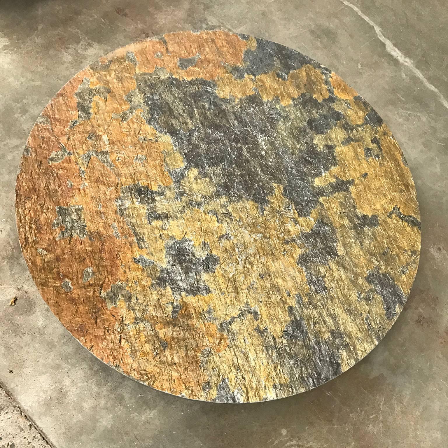 Iconic Dutch round coffee-table with stone top with metal black base. Heavy natural stone top with beautiful shiny colors. In the centre is a little hole. The base shows traces of use like some scratches and spots. The base consists of two parts