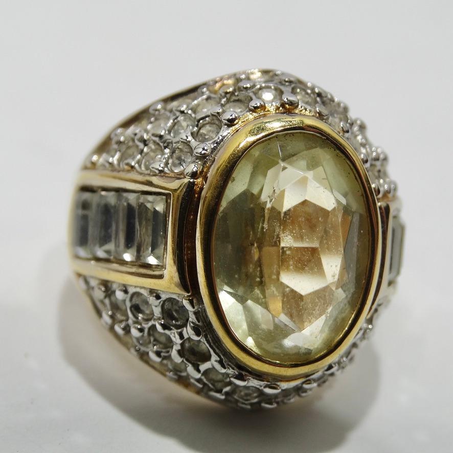 Stunning 18K gold plated dome ring circa 1970! This unique ring features a Citrine stone at the center surrounded by a plethora of square cut and circular rhinestones that allow the stone to really pop! The yellow gold really ties everything