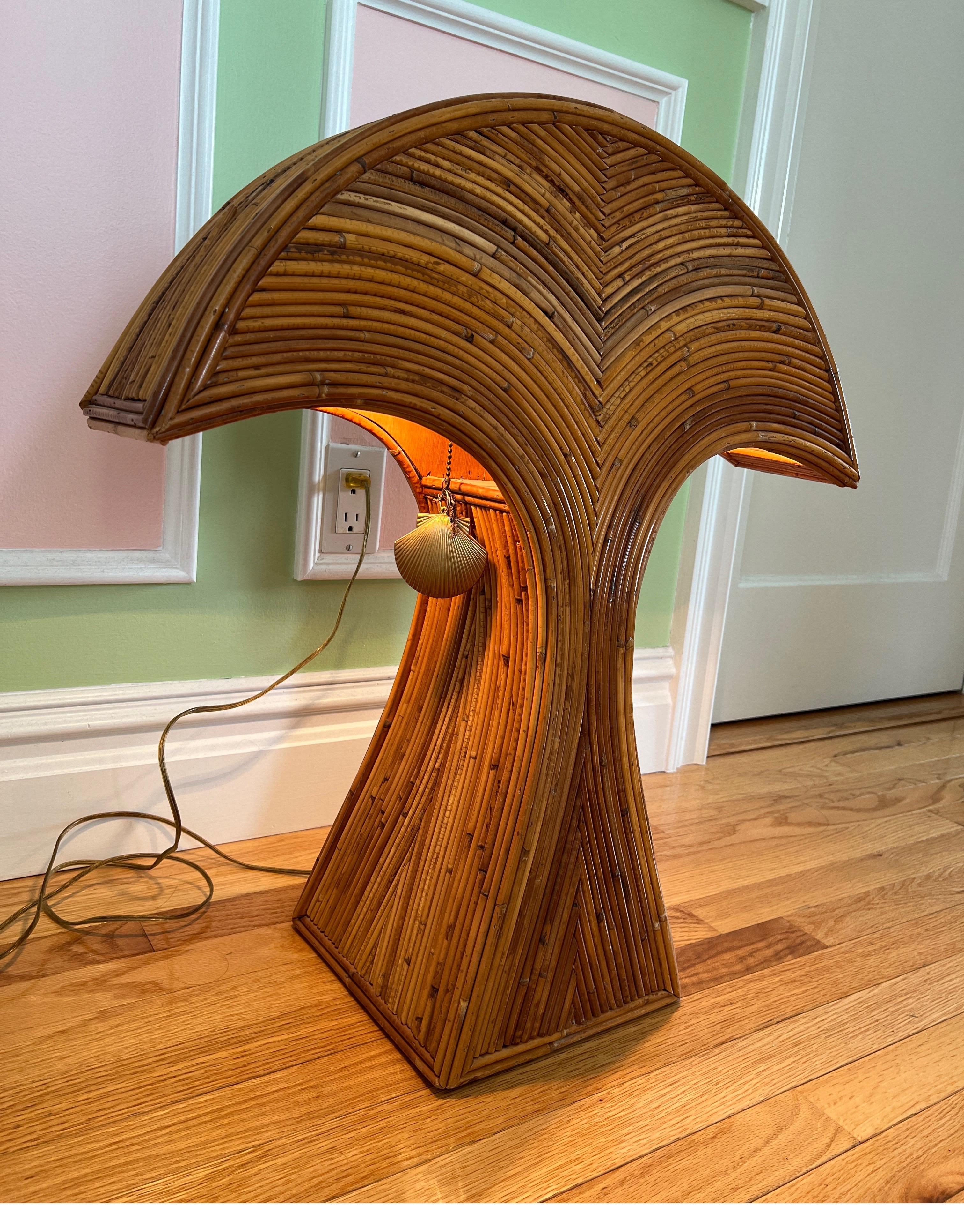 1970 Bamboo Arched Table Lamp, made in Philippines

There are two shell shaped pull chains where you can turn on just the left or right side of the light bulb. Perfect statement piece in a large space such as living room or on a entry table
