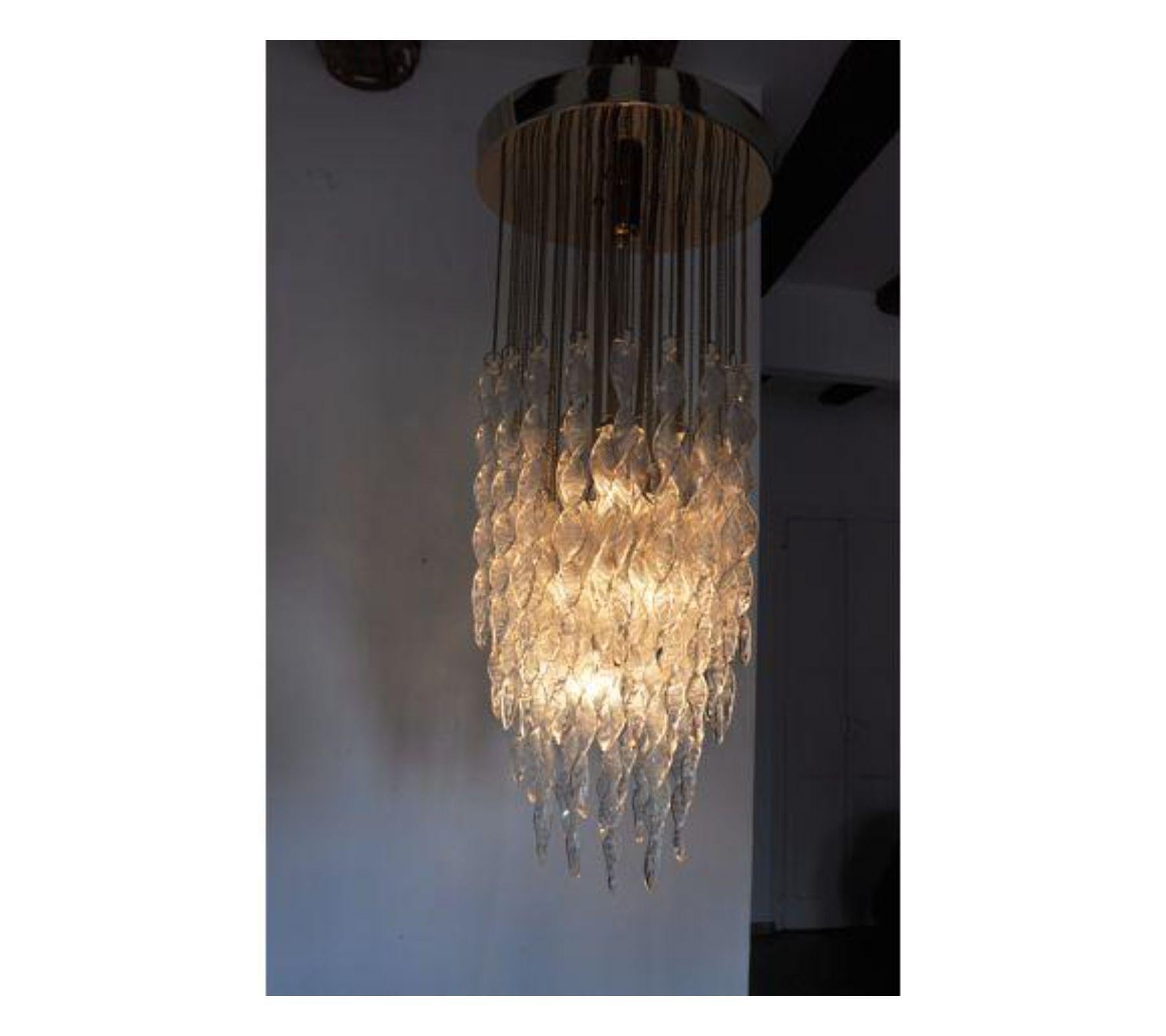Rare and impressive waterfall Murano Mazzega chandelier designed and produced in Italy around 1970. Brass structure composed of more than 70 Murano crystals peaks. A magnificent objet and unique piece of design that will be great a highlight to your