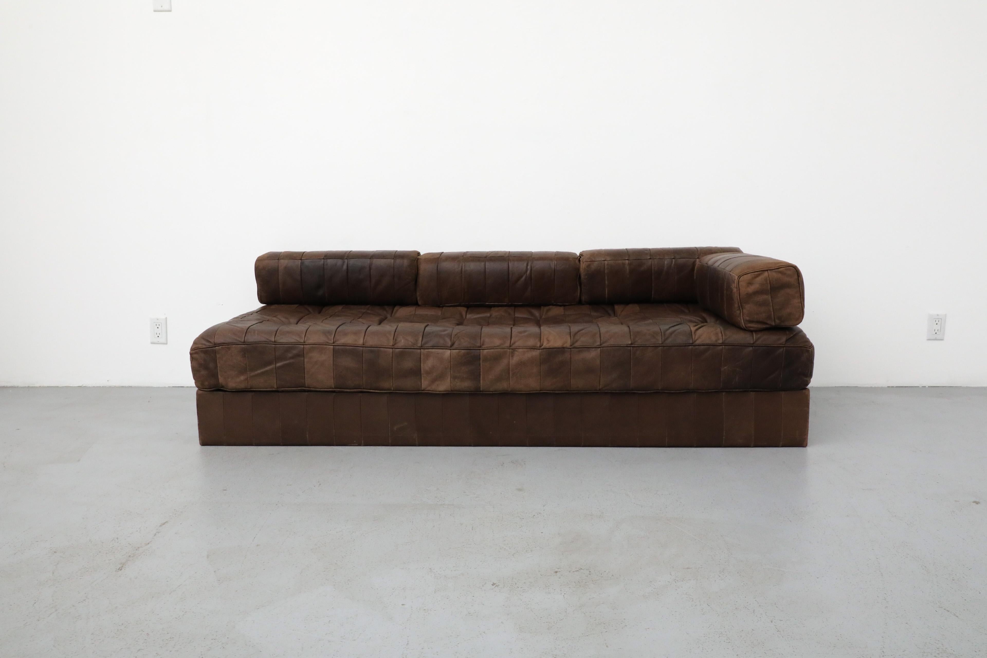 De Sede DS80 chocolate leather patchwork sofa/daybed, 1970. Upholstered in beautiful and soft original leather with amazing wear. The DS80 sofa showcases all of the characteristics of De Sede‘s furniture. Exceptional manufacturing standards,