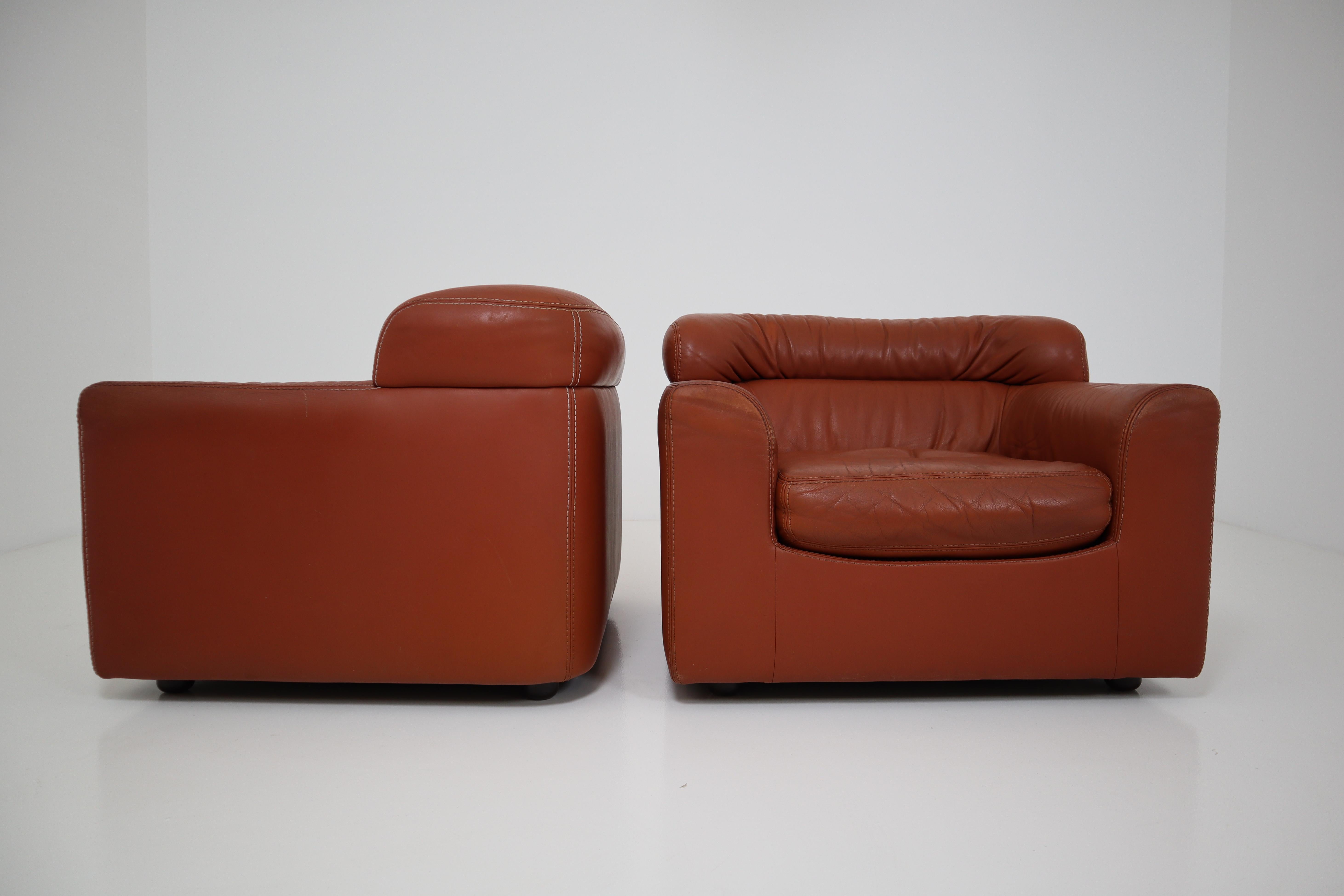 Armchairs by Durlet with striking and elegant proportions. An in-house, design from the mid-1970s, executed in thick buffalo cognac leather. Durlet is a family business specializing in working with leathers (much like De Sede), known for it's