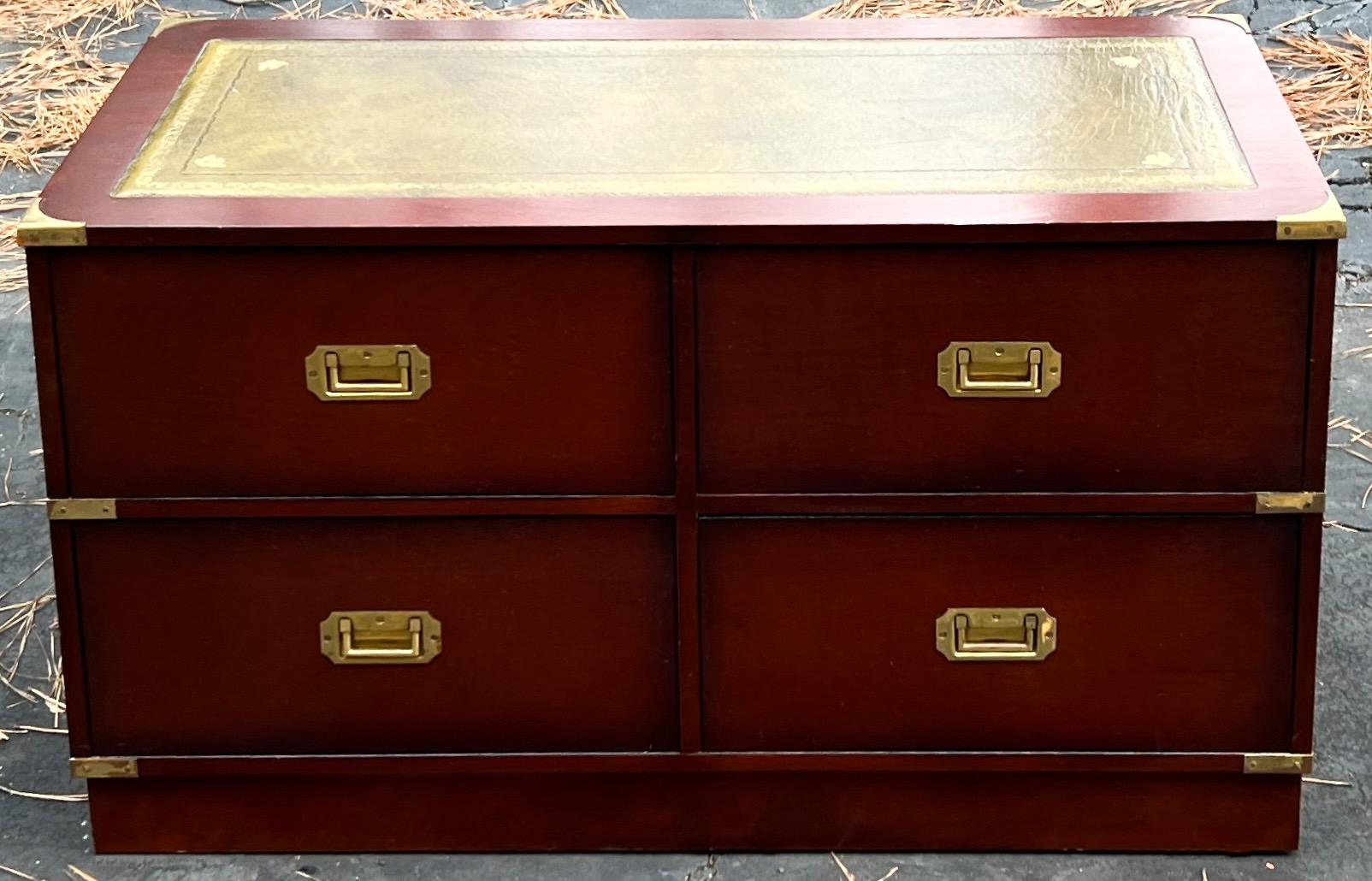 Timeless appeal! From coffee table to foot of the bed, this English campaign style trunk is just the right piece. The drawers and green leather top complete the look. It is marked Doherty / London in the drawer. The drawers have dovetail