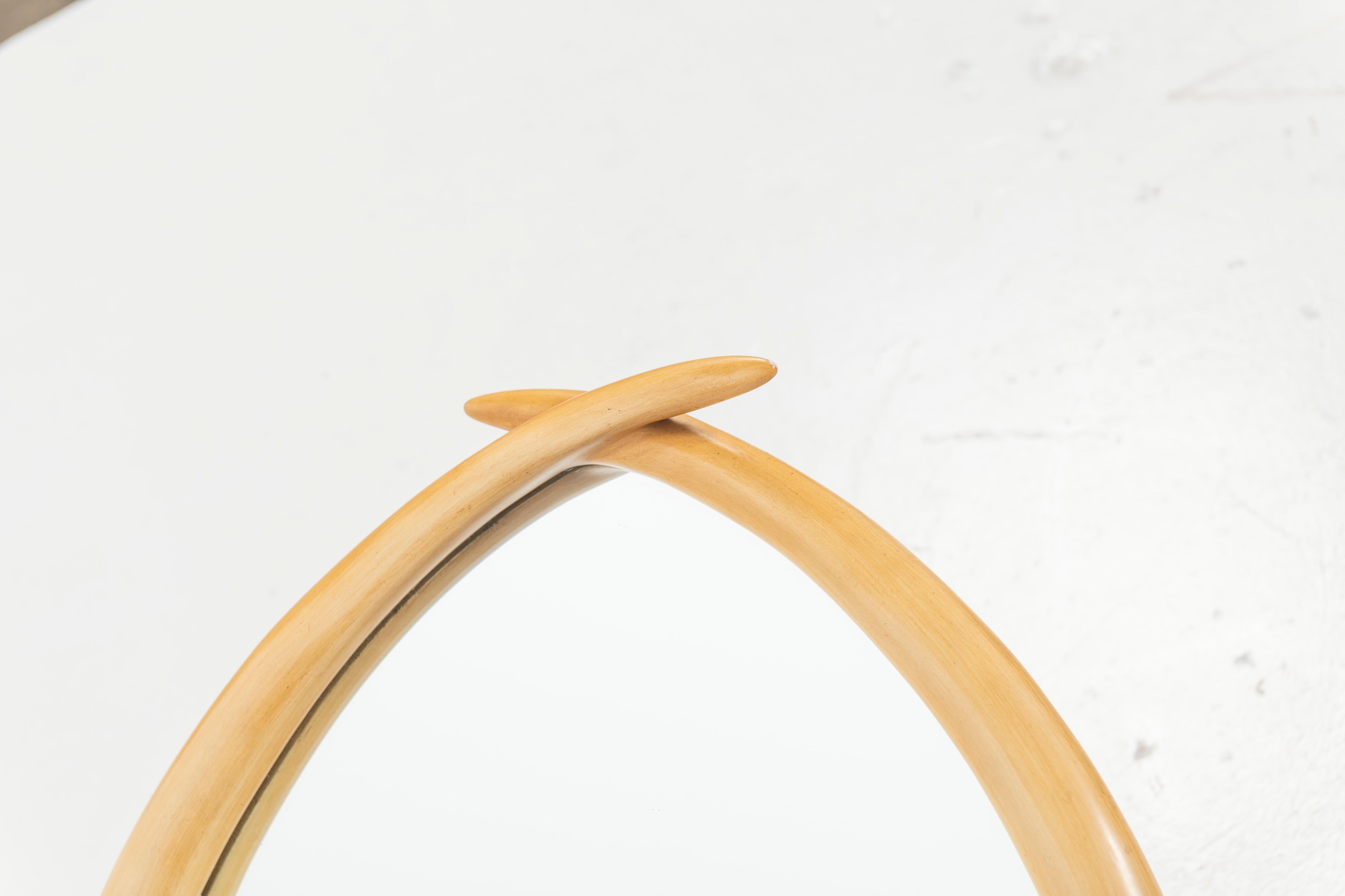 Unusual modern faux tusk mirror with patinated brass accents manufactured by Chapman in 1976. Made of a composite material, the mirror is of quality construction and a great size. Makers sticker is on the back.