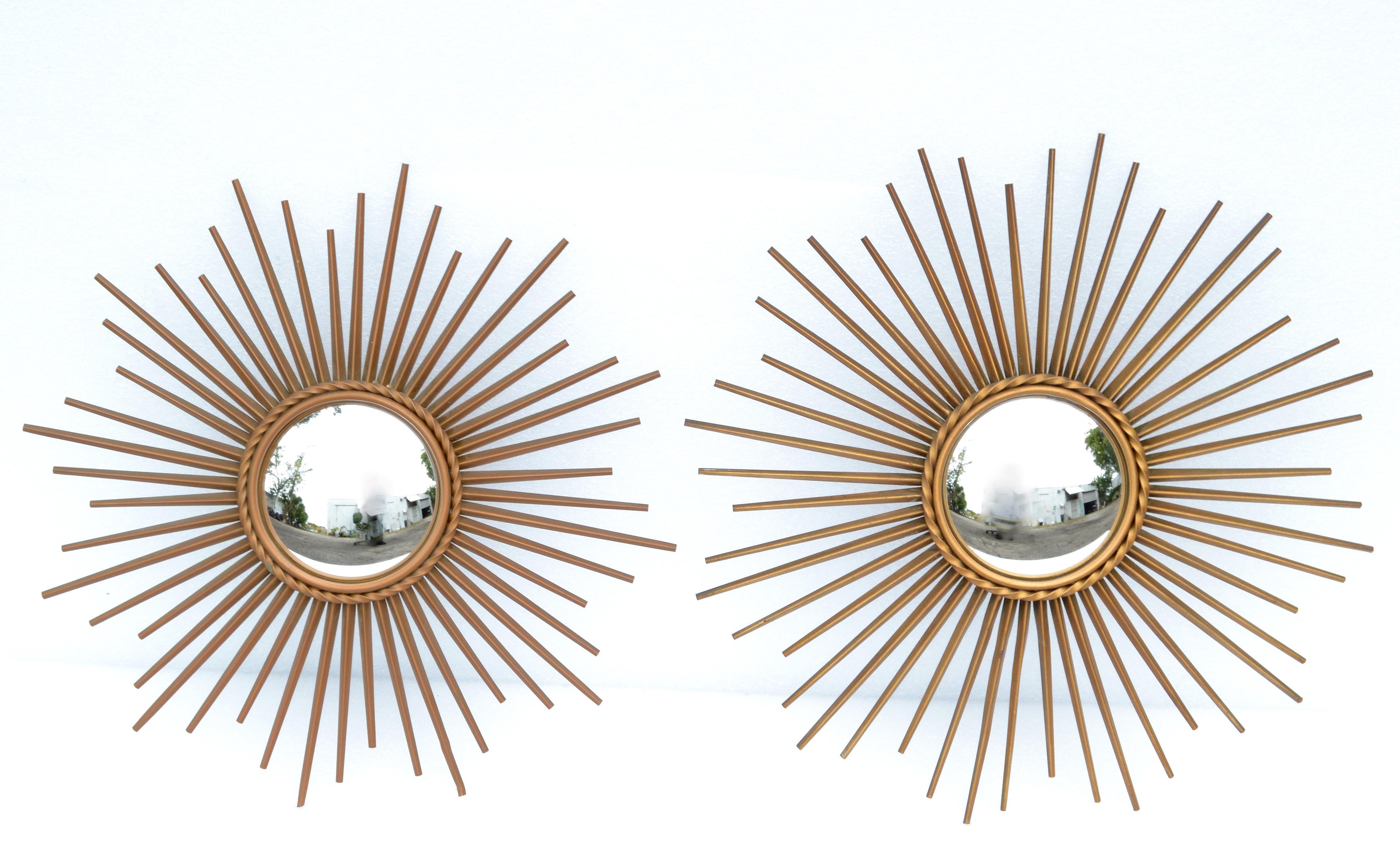 Two 19.5 inches diameter French Mid-Century Modern convex sunburst mirror by Chaty Vallauris and made in the 1970s.
Stunning handcrafted iron overlaid in brass finish with a 5.5 inches convex mirror in the center.
Made in Vallauris, France.
  