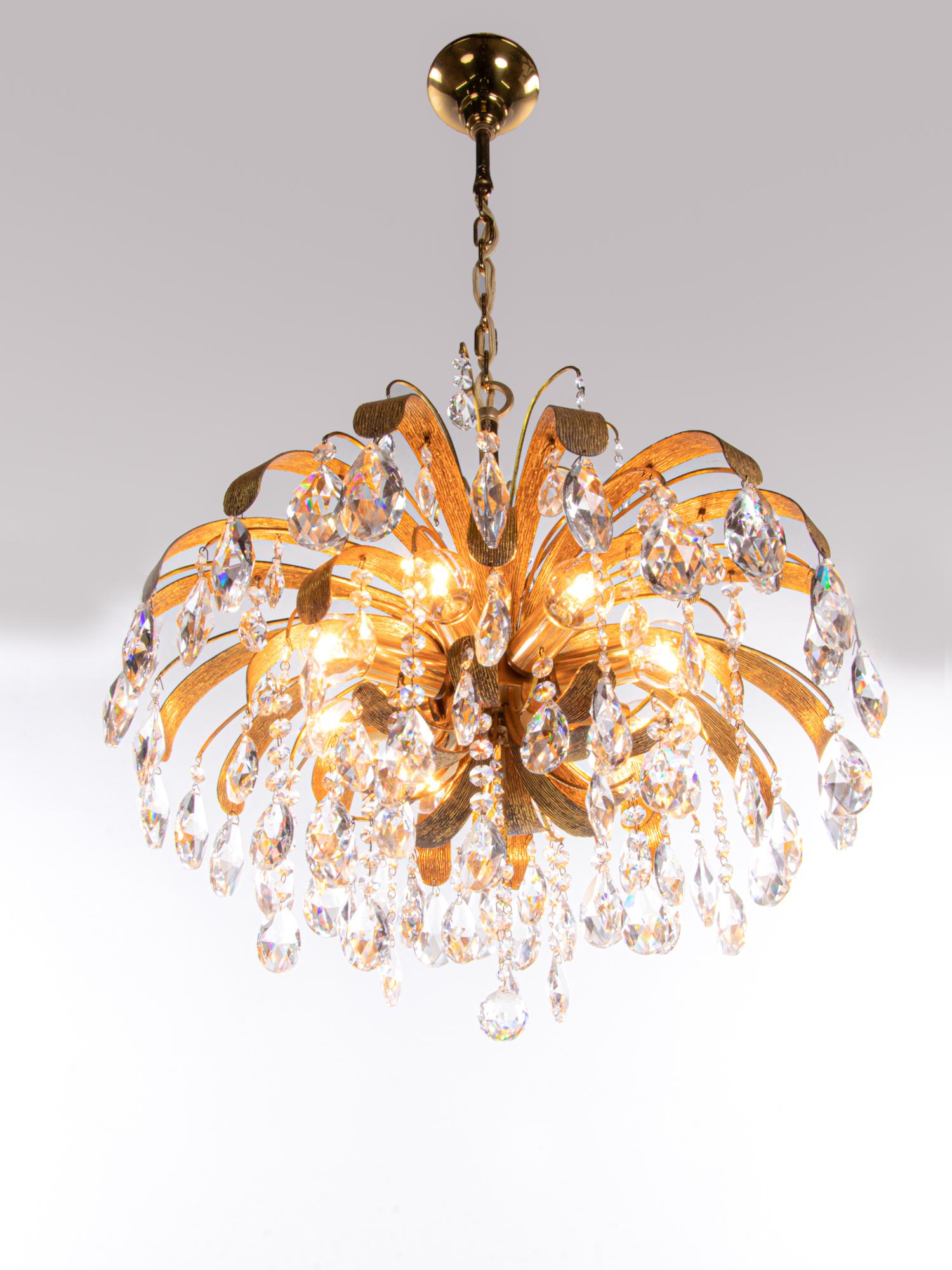 Beautiful cascading gilt brass leaf crystal chandelier designed by Christoph Palme. Chandelier illuminates beautifully and offers a lot of light. 

Gem from the time. With this light you make a clear statement in your interior design. A real