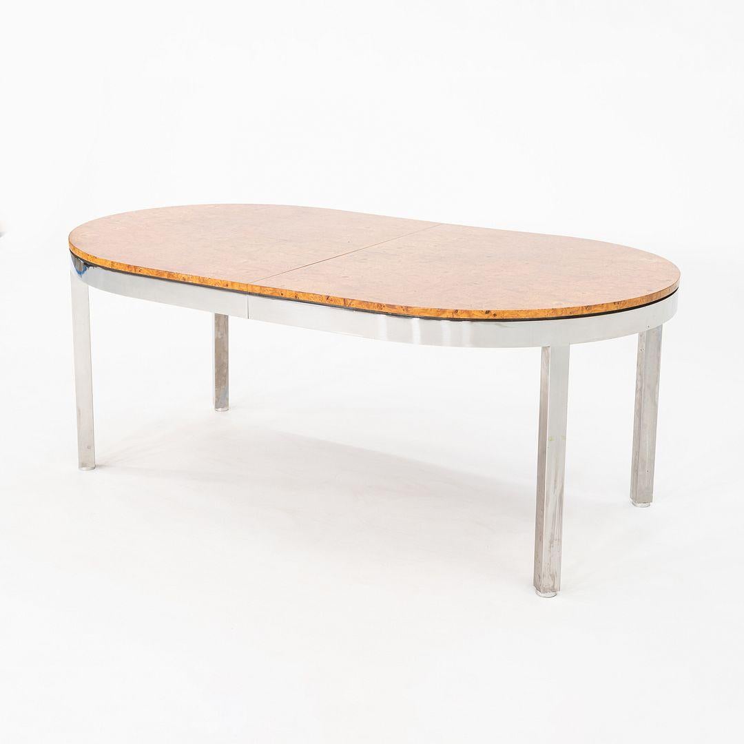 This is a 1970 Model 967 Dining Table, having a book matched burled wood top, and a chromed steel base. We were able to find an original advertisement of this table in a 1970 issue of Interiors Magazine noting it as a design by I.M. Rosen for Pace