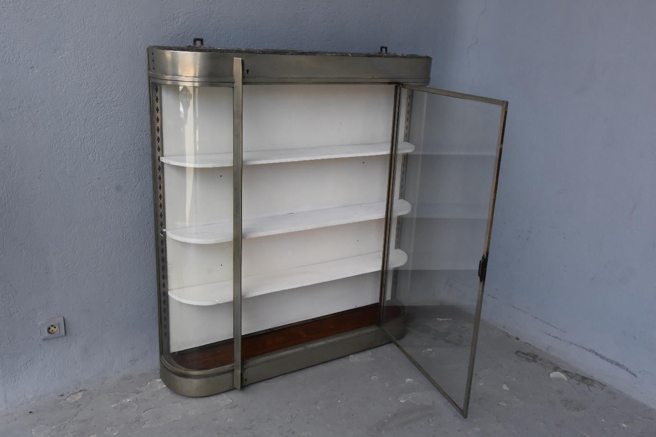 Large showcase in glass and chromed metal vintage 1970 height dimension 130 cm for a width of 120 cm and a depth of 21 cm.
