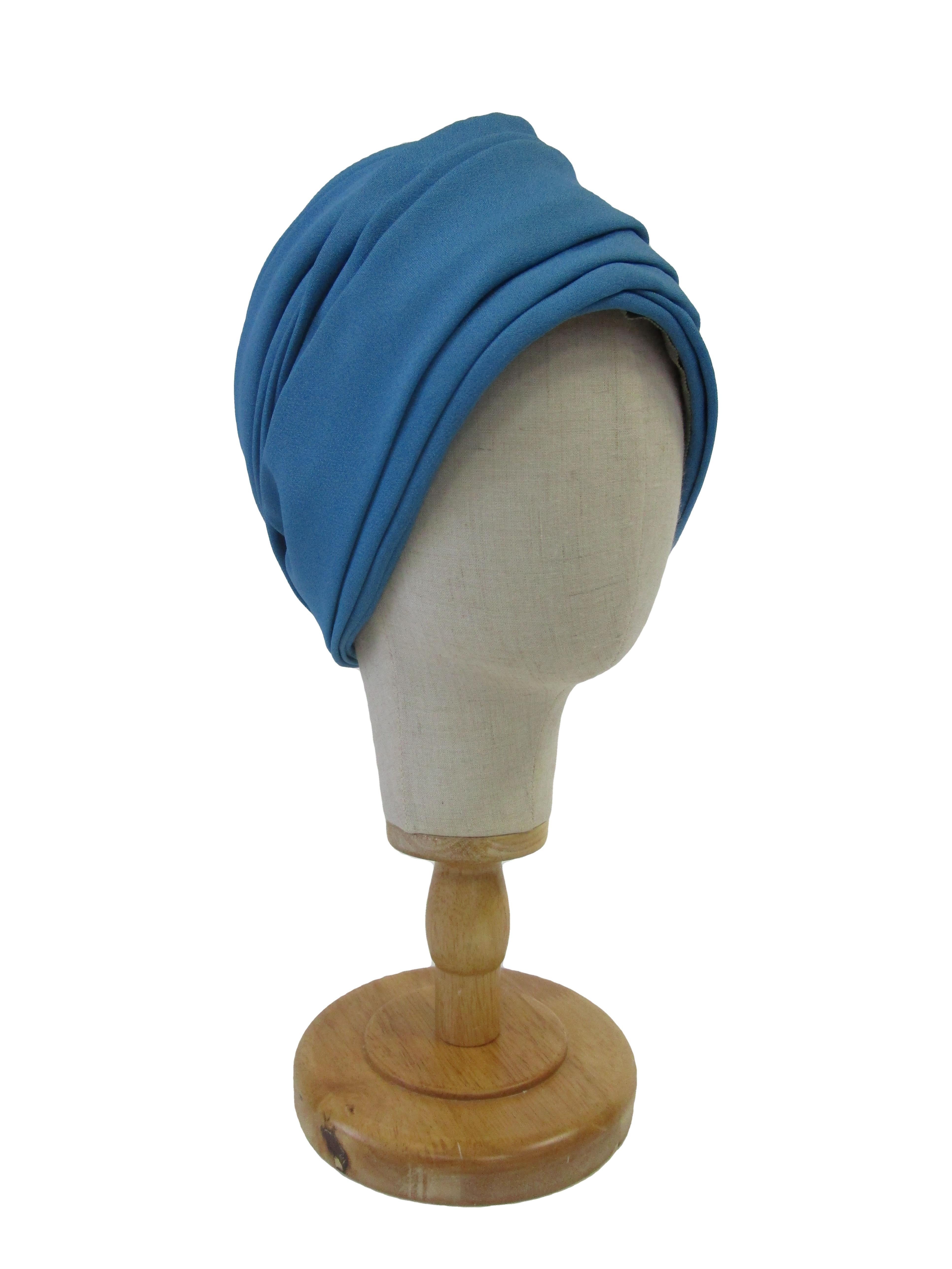 

Beautiful sparkling cobalt knit turban from the millinery masters Leslie Masters and James Druce. Perfection in design, execution, fit, and fun! 

It features a lurex knit body with delicate stitching that keeps the hat in shape. It has a slight