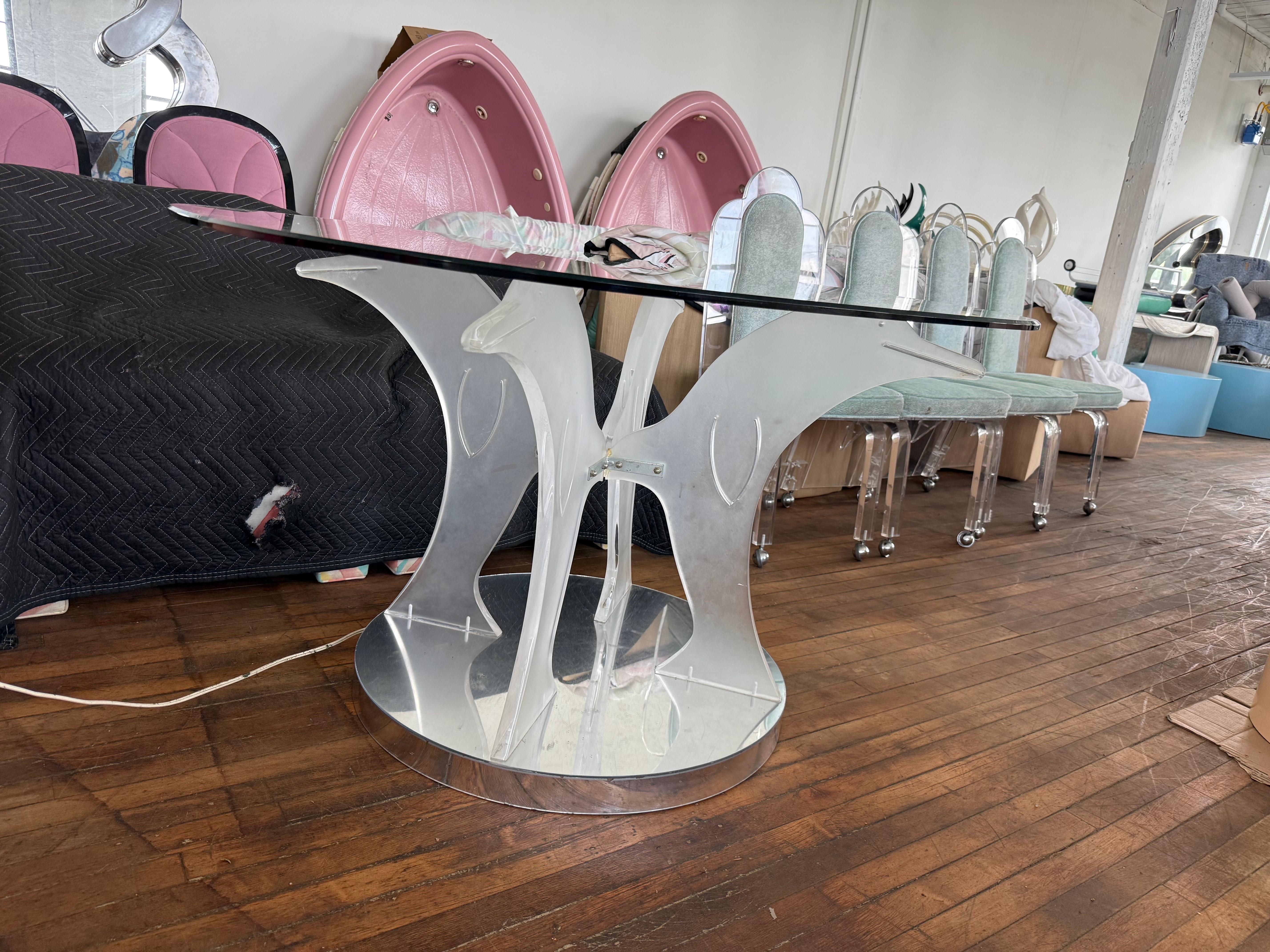 1970 Lucite Light Up Dolphins Dining Table, custom made in Florida.

The original owner ordered this back in 1973. The base is made of mirror and there is a switch to turn on the light on the bottom of the mirrored base.

glass
47.5x47

dolphin