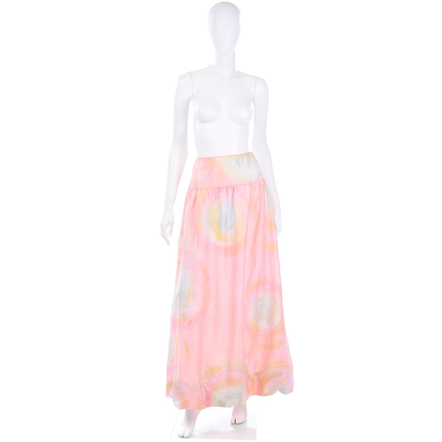 This is a lovely vintage silk pink, blue and yellow vintage Mary McFadden watercolor maxi skirt with a really fun bubble hem. The hand dyed design looks almost like tye dye! This pretty pastel vintage skirt has a wide waistband and closes with a