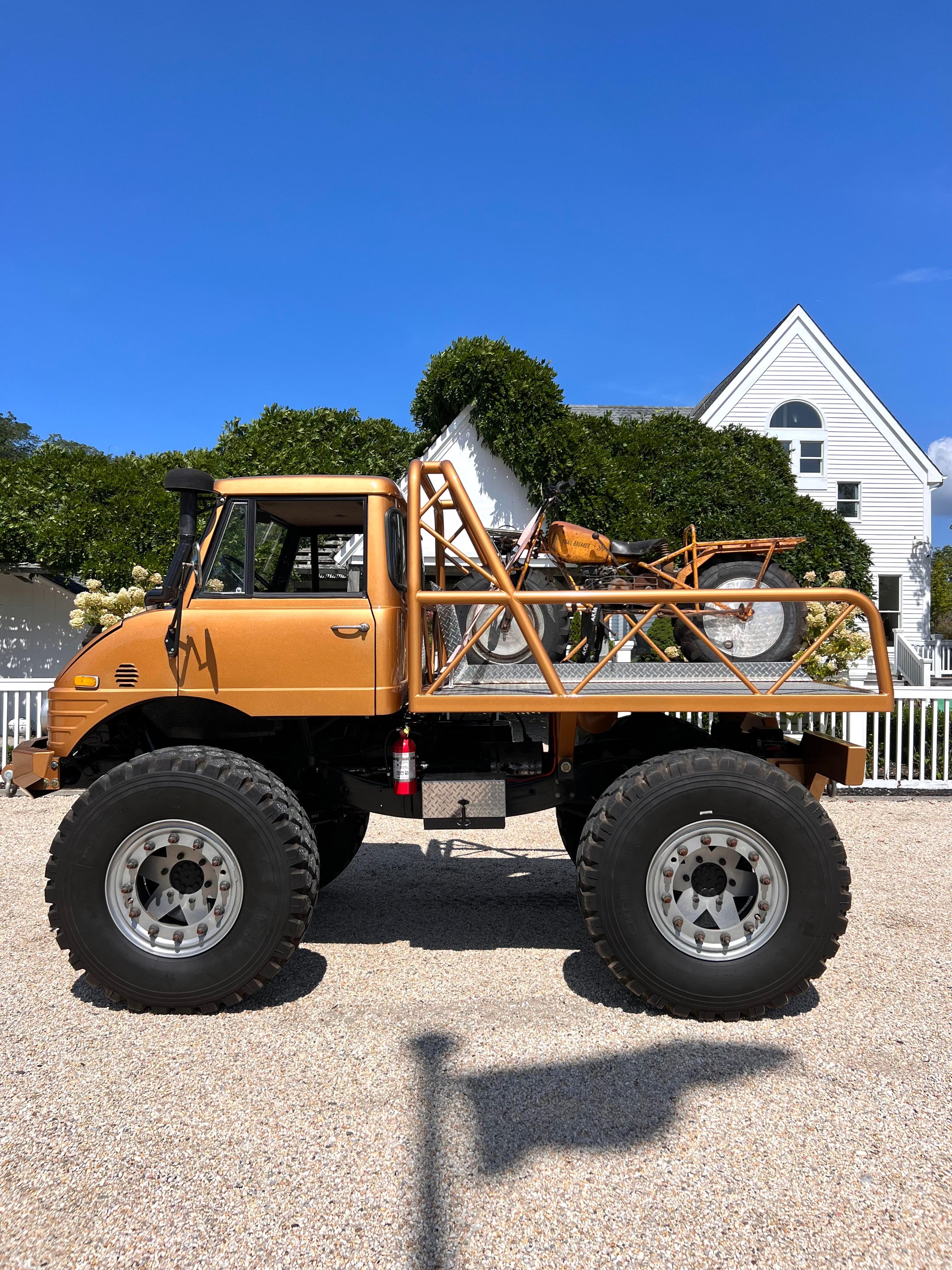 Incredible 1970 Mercedes Benz 406 Unimog in gold. Sold with a matching late 1960s Rokon Trailbreaker motorcycle strapped to the truckbed. Extremely heavy duty and powerful Mercedes truck. Engine recently serviced and in excellent condition. Working