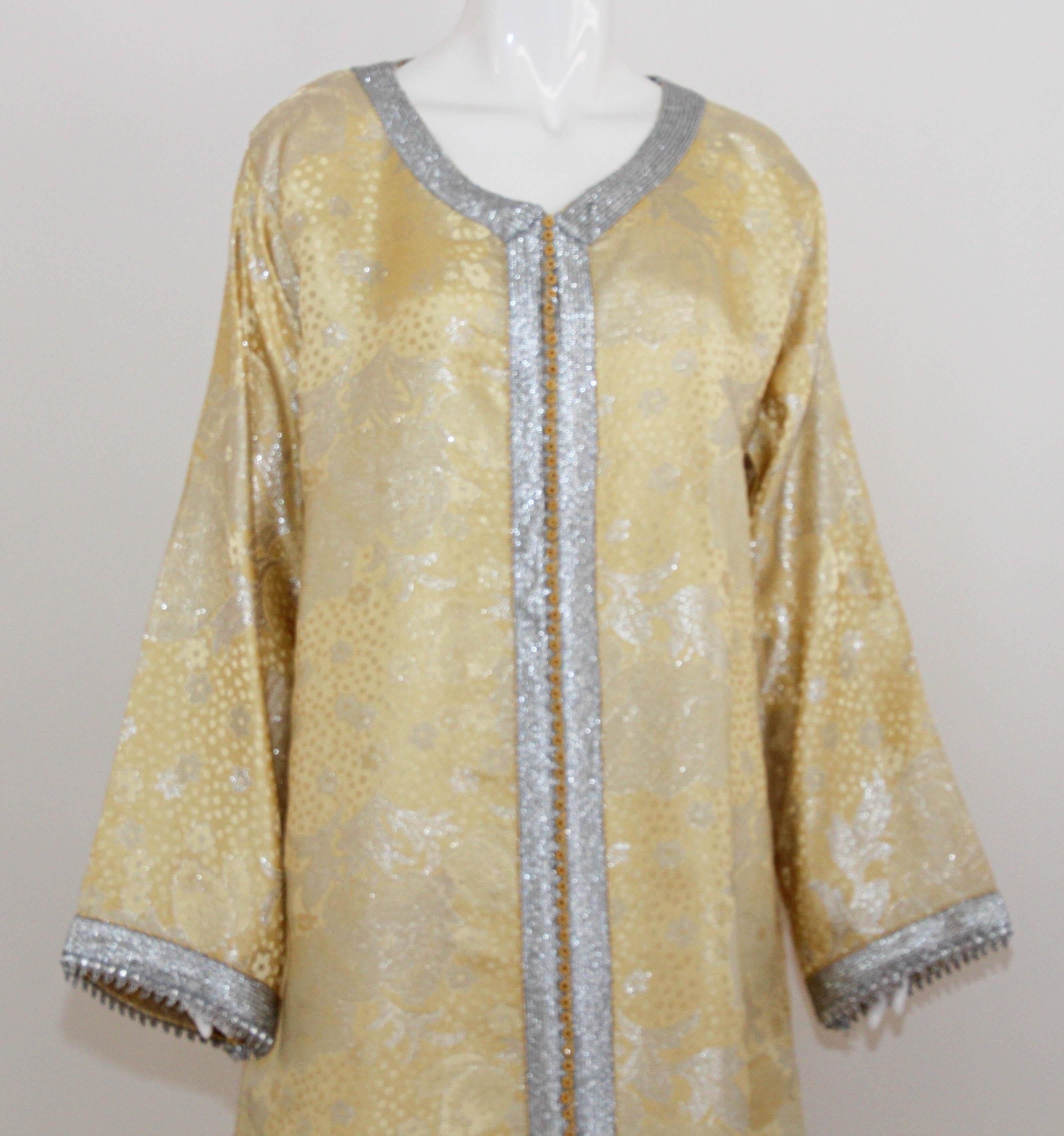 Evening or interior metallic gold brocade dress kaftan with silver and gold trim.
Hand-made ceremonial caftan from North Africa, Morocco.
Vintage exotic 1970s silver metallic brocade caftan gown.
The luminous gold metallic caftan maxi dress caftan