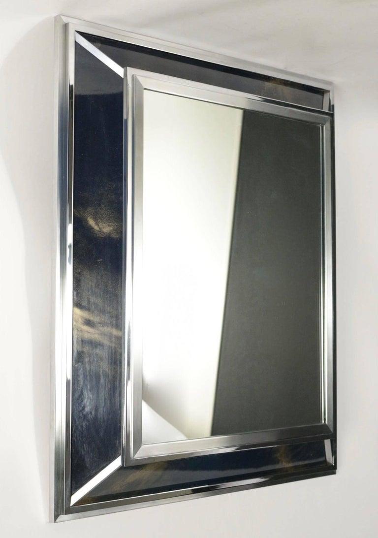 1970 mirror by Maison Roche
The edge of the mirror is made of chrome and brushed steel, the frame is covered with iridescent midnight blue lacquer plates, dotted with gold.
In the center, a rectangular mirror completes the set.
 