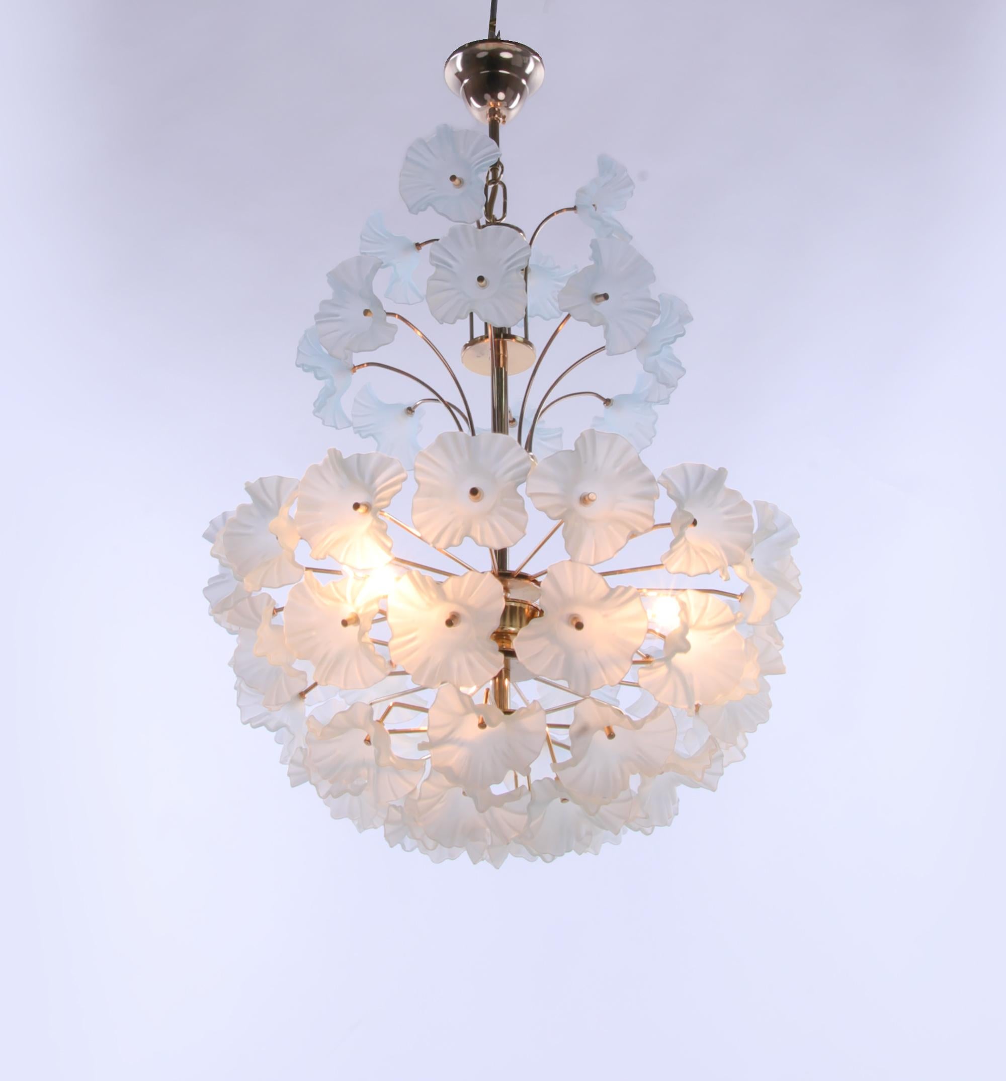 Elegant modernist hibiscus flower bouquet chandelier with turquoise glass flowers on a brass frame. Chandelier illuminates beautifully and offers a lot of light. Gem from the time. 
With this light you make a clear statement in your interior design.