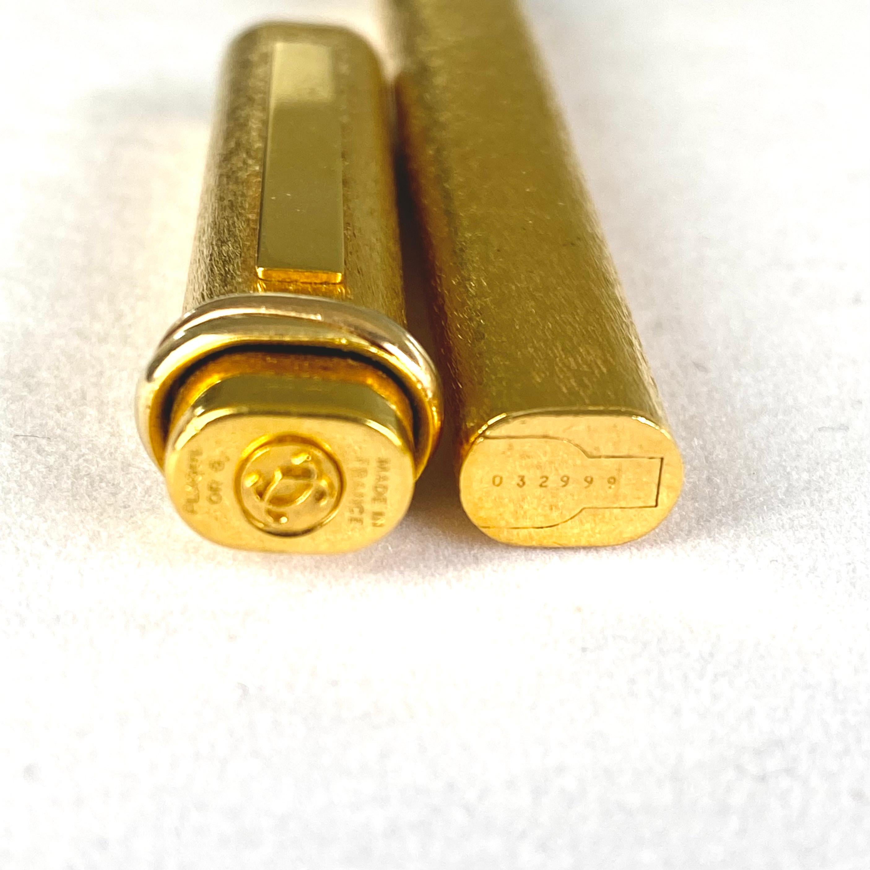 Indulge in the timeless allure of the 1970 Must De Cartier Gold-Plated Ballpoint Pen, a masterpiece that seamlessly blends opulence and functionality. Crafted with precision and bearing the esteemed Cartier legacy, this pen is not just a writing