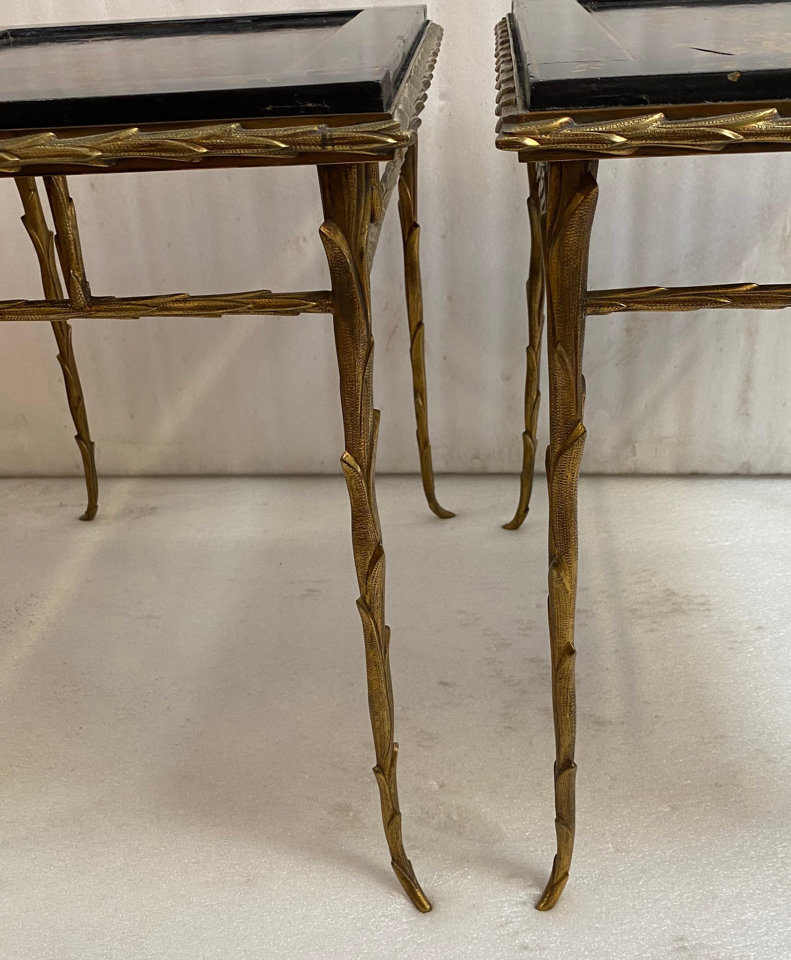 1970′ Pair of double-sided decorative end tables, lacquered top decorated with mountain landscapes featuring pagodas and palaces on one side, the concave reverse side decorated with branches and flowers, the panel surround decorated with floral