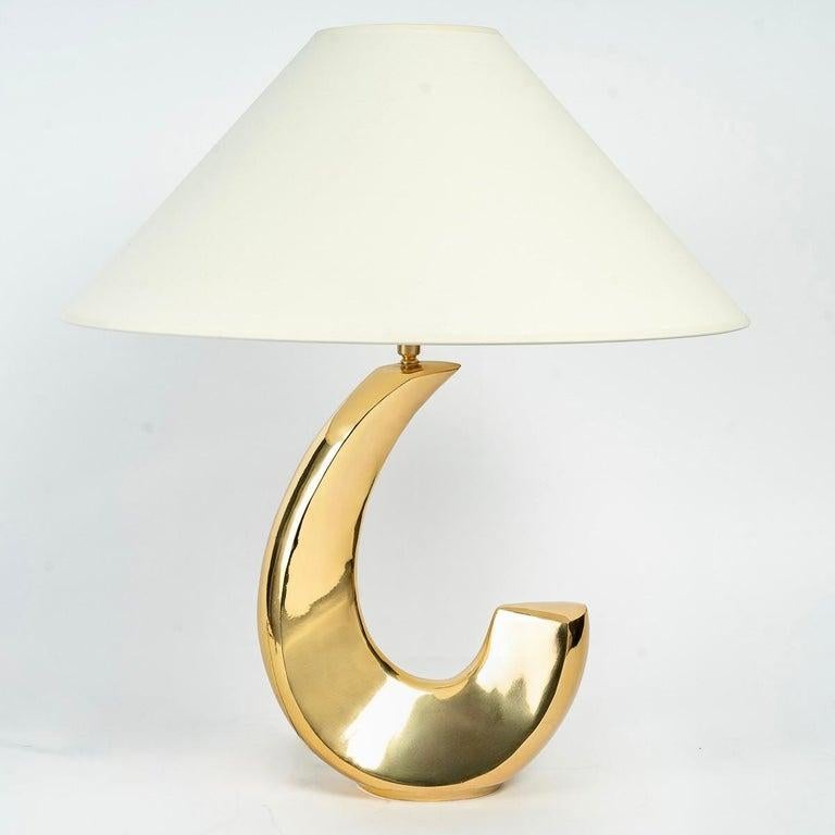 Pair of beautiful lamps in solid gold brass.

Composed of a solid gold brass base inspired by the birth of the roll of a wave.
They are dressed with off-white cotton lampshade redone identically in the form of Chinese hat.

1 arm of light by lamp.