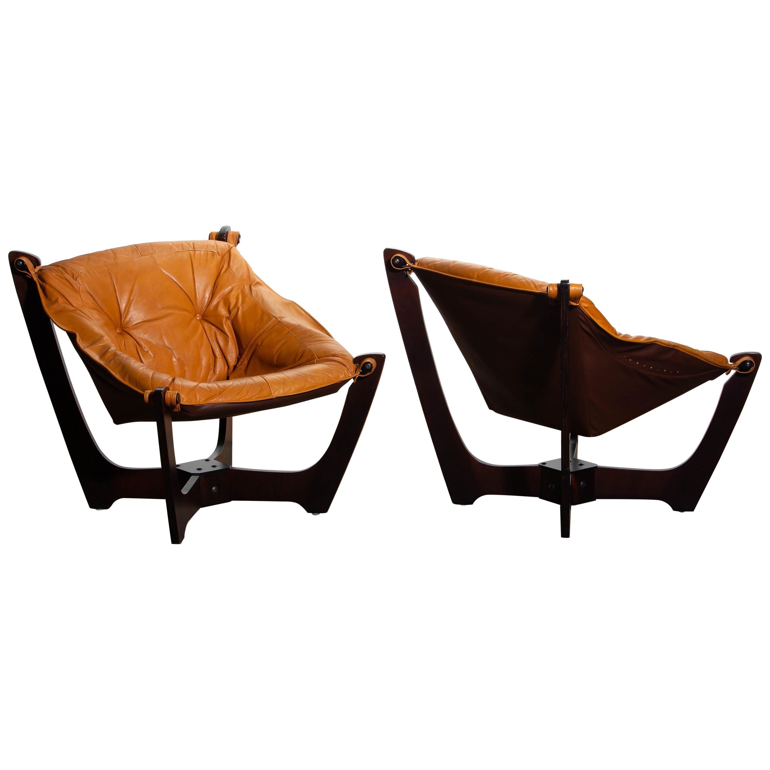 Beautiful set of two 'Luna' armchairs by Odd Knutsen for Hjellegjerde Norway in camel / cognac leather with dark brown beech laminated frames.
This chairs are in overall good condition.

 