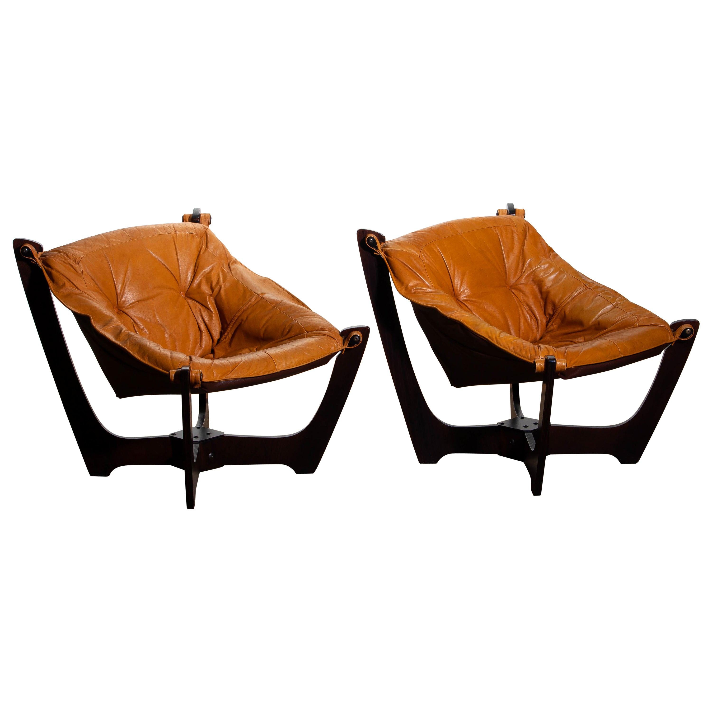 Beautiful set of two 'Luna' armchairs by Odd Knutsen for Hjellegjerde Norway in camel / cognac leather with dark brown beech laminated frames.
This chairs are in overall good condition.

 