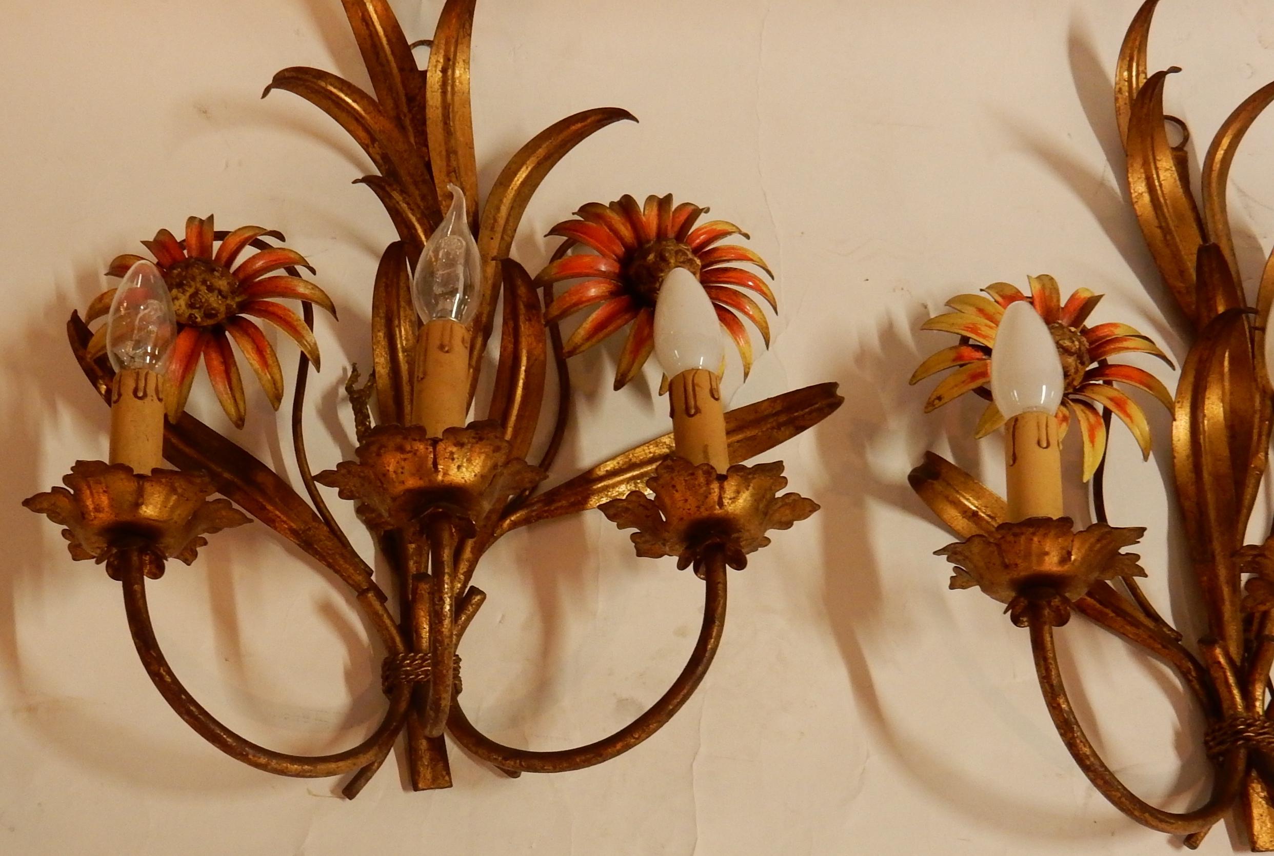 Pair of gilt metal sconces, 3 bulbs. Adorned with metal leaves and sunflowers
Condition of use, circa 1970.

 
