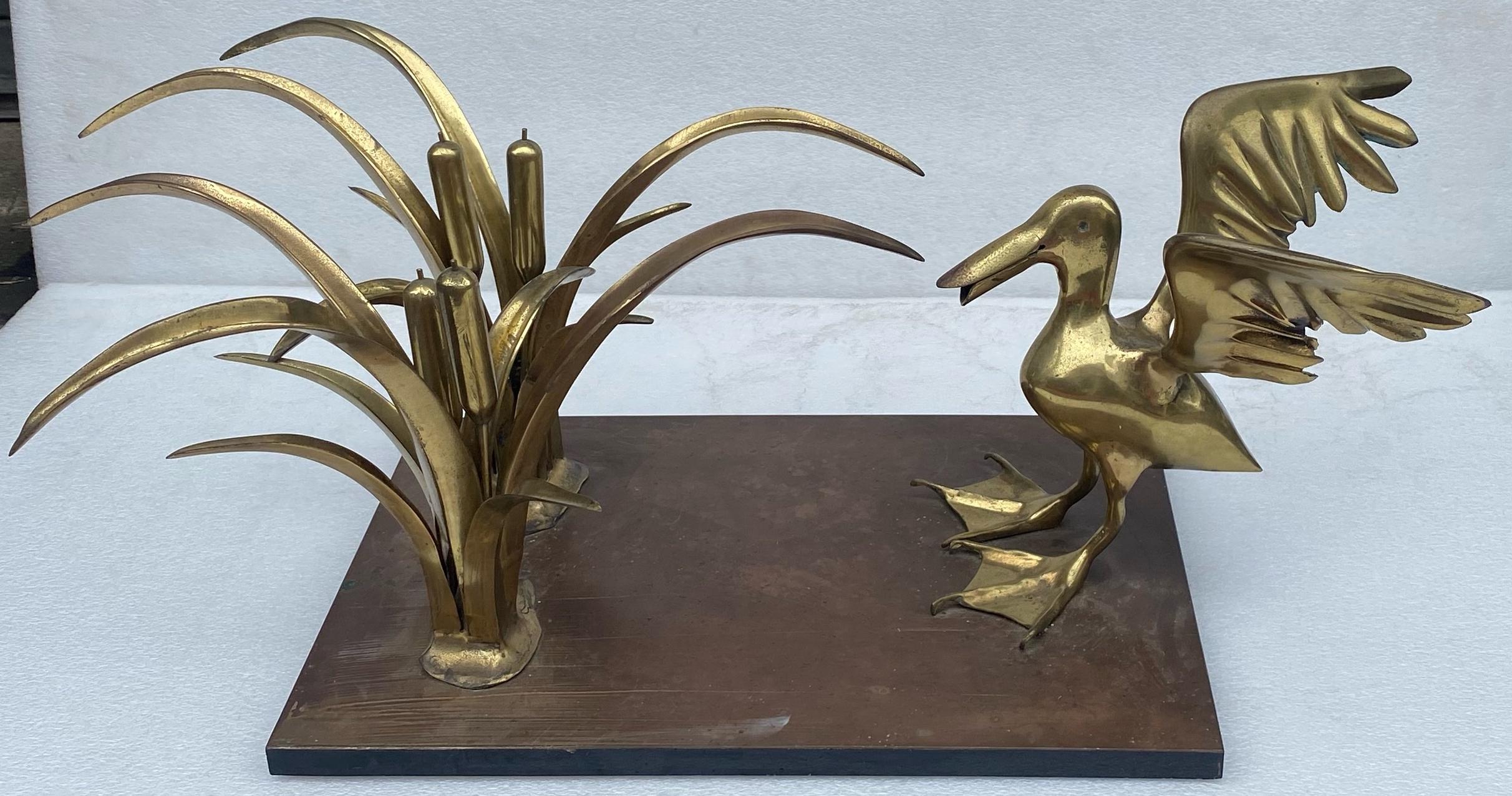 Gilt bronze coffee table with a pelican and a reed bush.
By Christian Techoueyres not signed.
Wooden base surrounded by black formica.
105 x 62cm
H 40 cm
Tempered glass top with corbin beak, condition of use.
130 x 70cm
1970, circa
condition