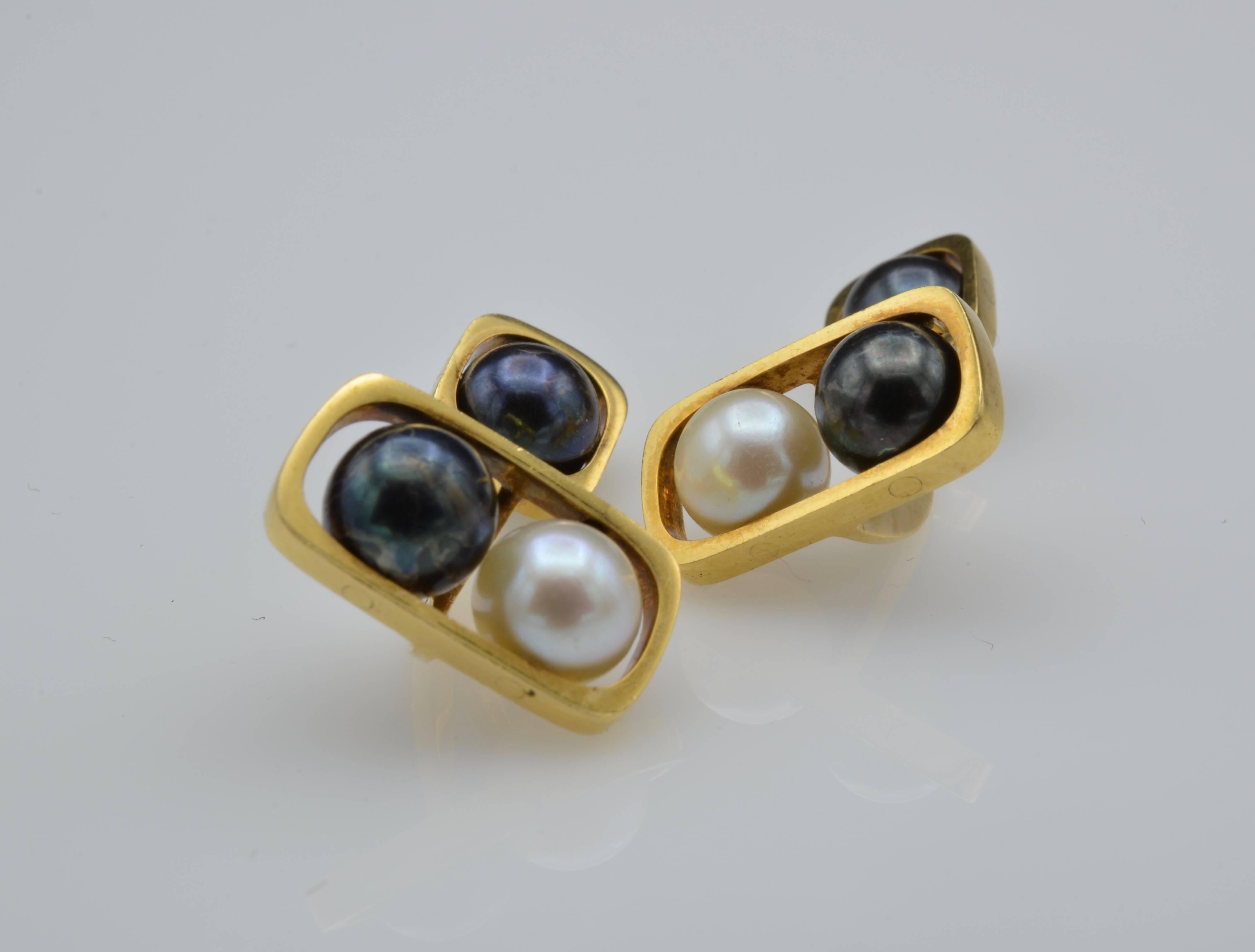 These handsome pearl and gold cufflinks and beautifully designed with white and black pearls suspended from an 18k gold modern framework. The pearls spin and create a stunning accent to any cuff.
These are very unusual and would make a very special