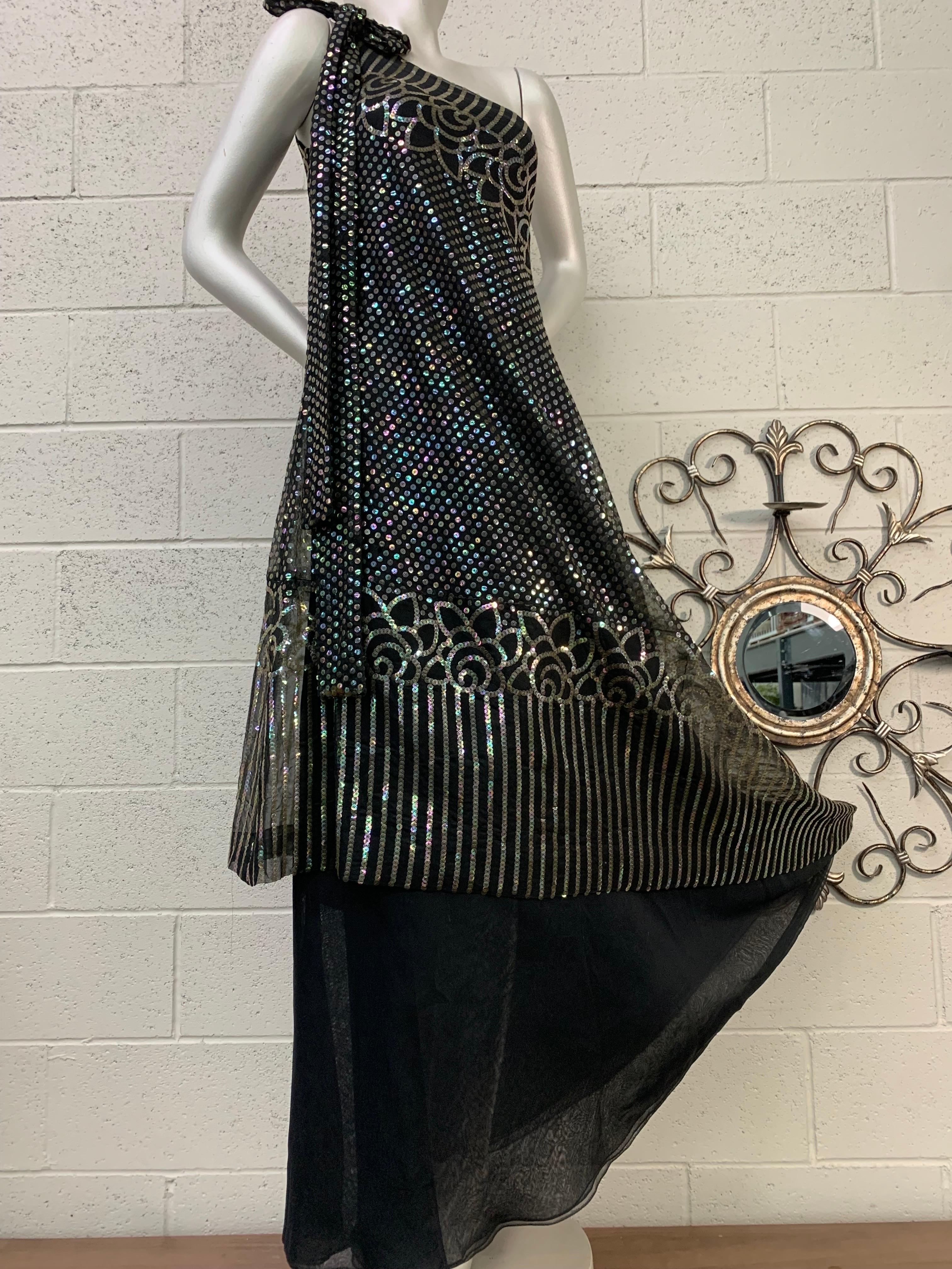 1970 Ruben Panis Black Chiffon Hologram Sequin Art Deco Styled One-Shoulder Gown: Asymmetrical shoulder closure with bow detail on double-layered  chiffon gown. Handkerchief hem sequined overlay features a spectacular Art Deco graphic design in