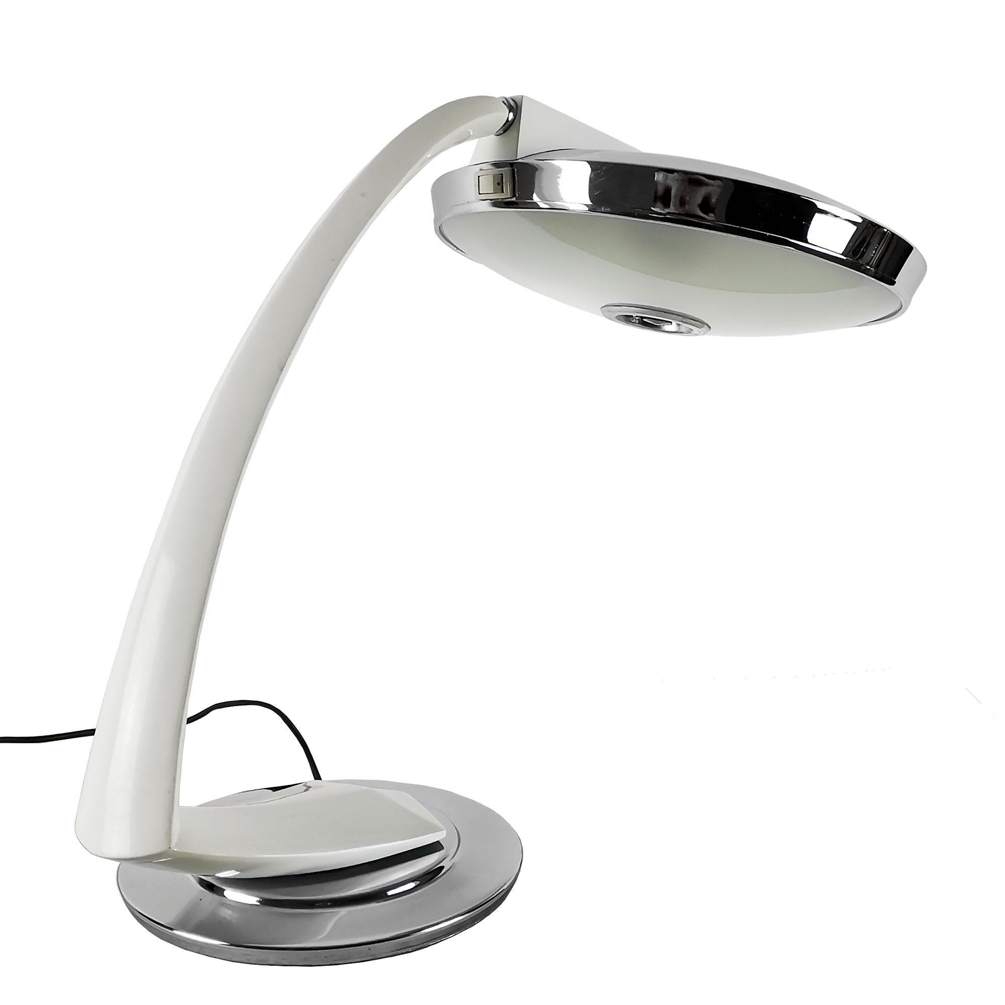 Large desk lamp, white enameled steel arm pivoting on a nickel plated metal round base, frosted glass diffuser with a nickel plated metal cover.
Model: Boomerang 2000
Maker: Fase (Stamp in the base)

Spain c. 1970.
