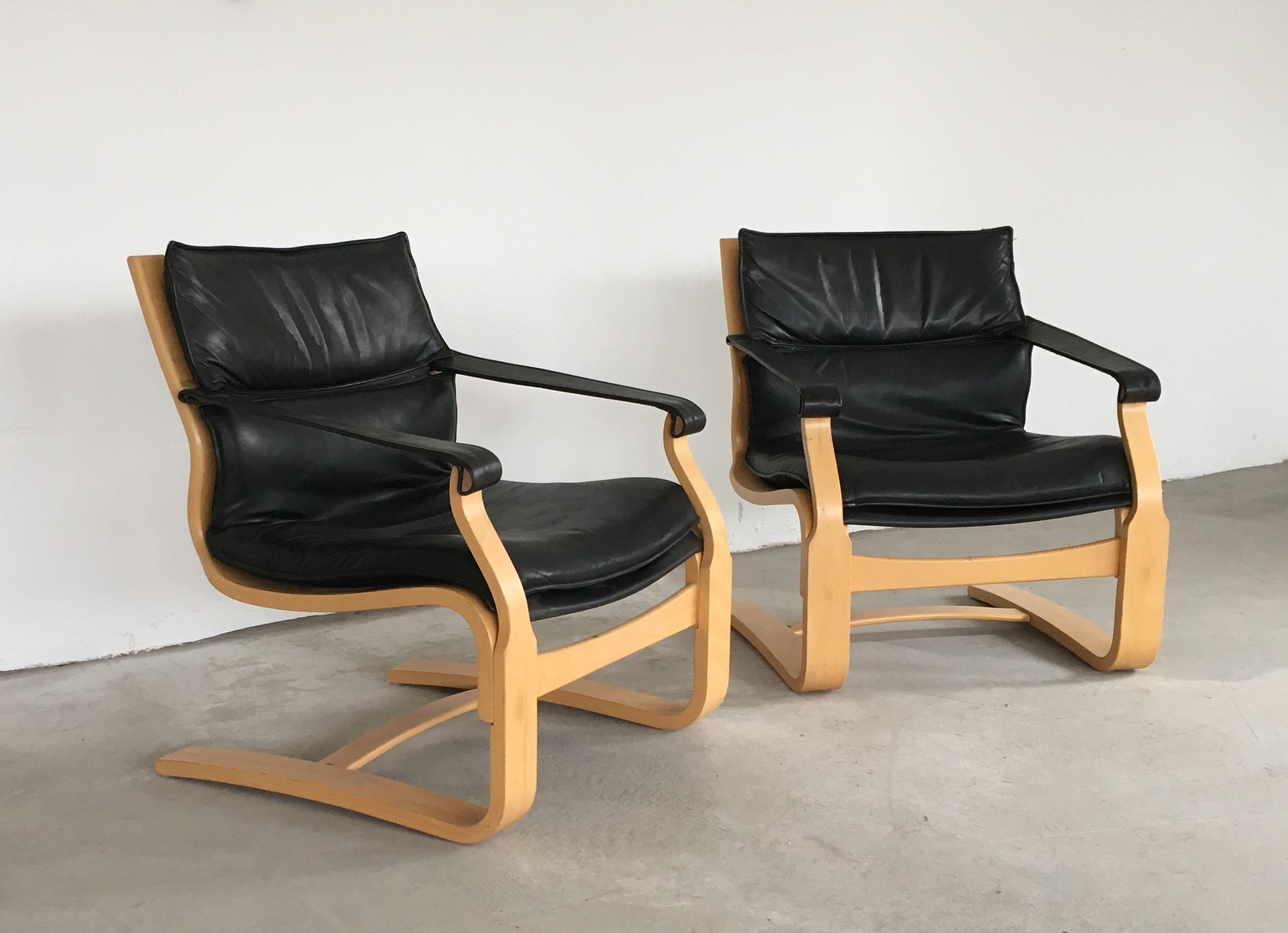 Pair of Åke Fribytter lounge chairs in beech and black leather by Nelo

The two comfortable lounge chairs have been examined by our cabinetmaker to ensure they are in good condition with only few and minor signs of age and use. 
The original leather