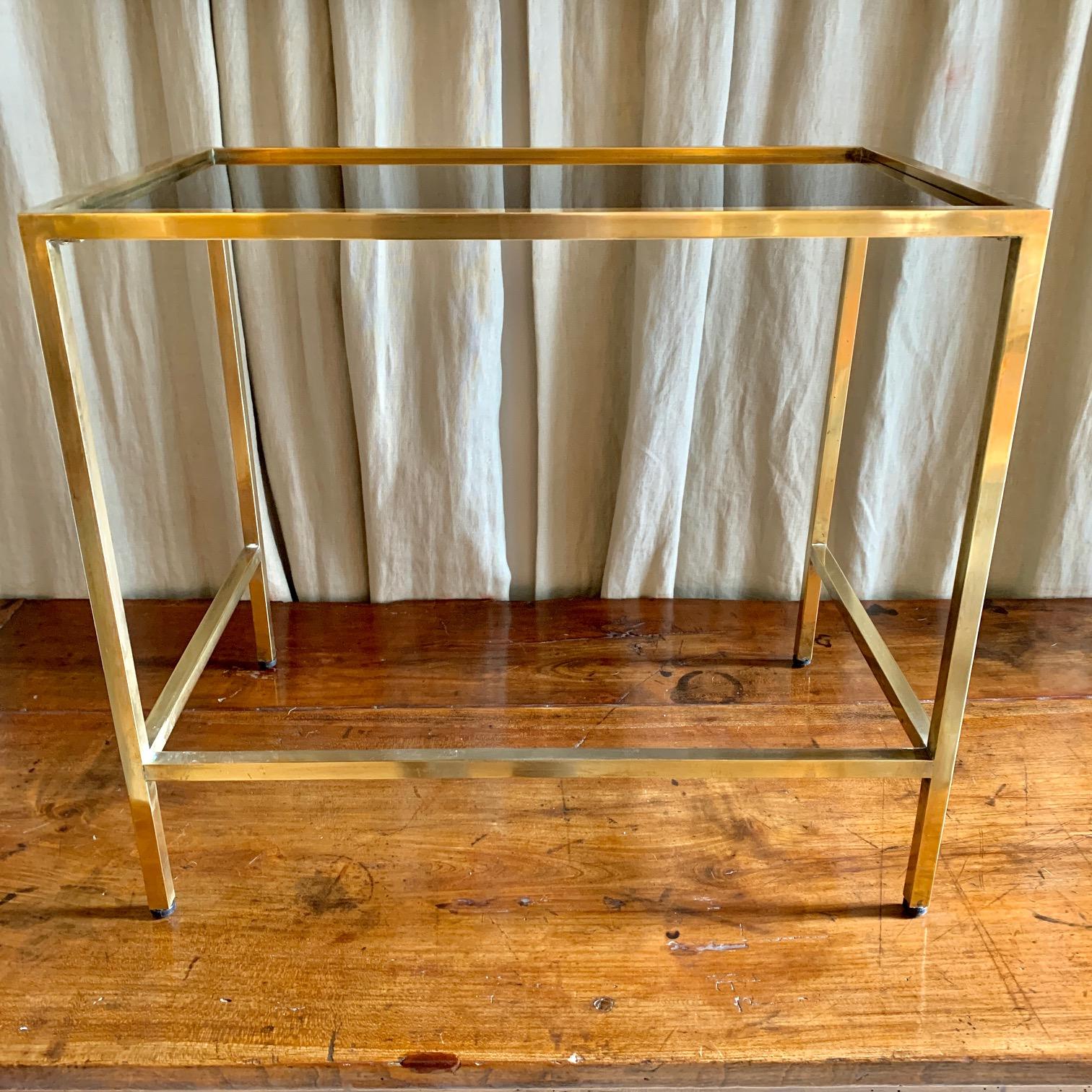 Small coffee table or side table, made of golden brass and black glass top.
