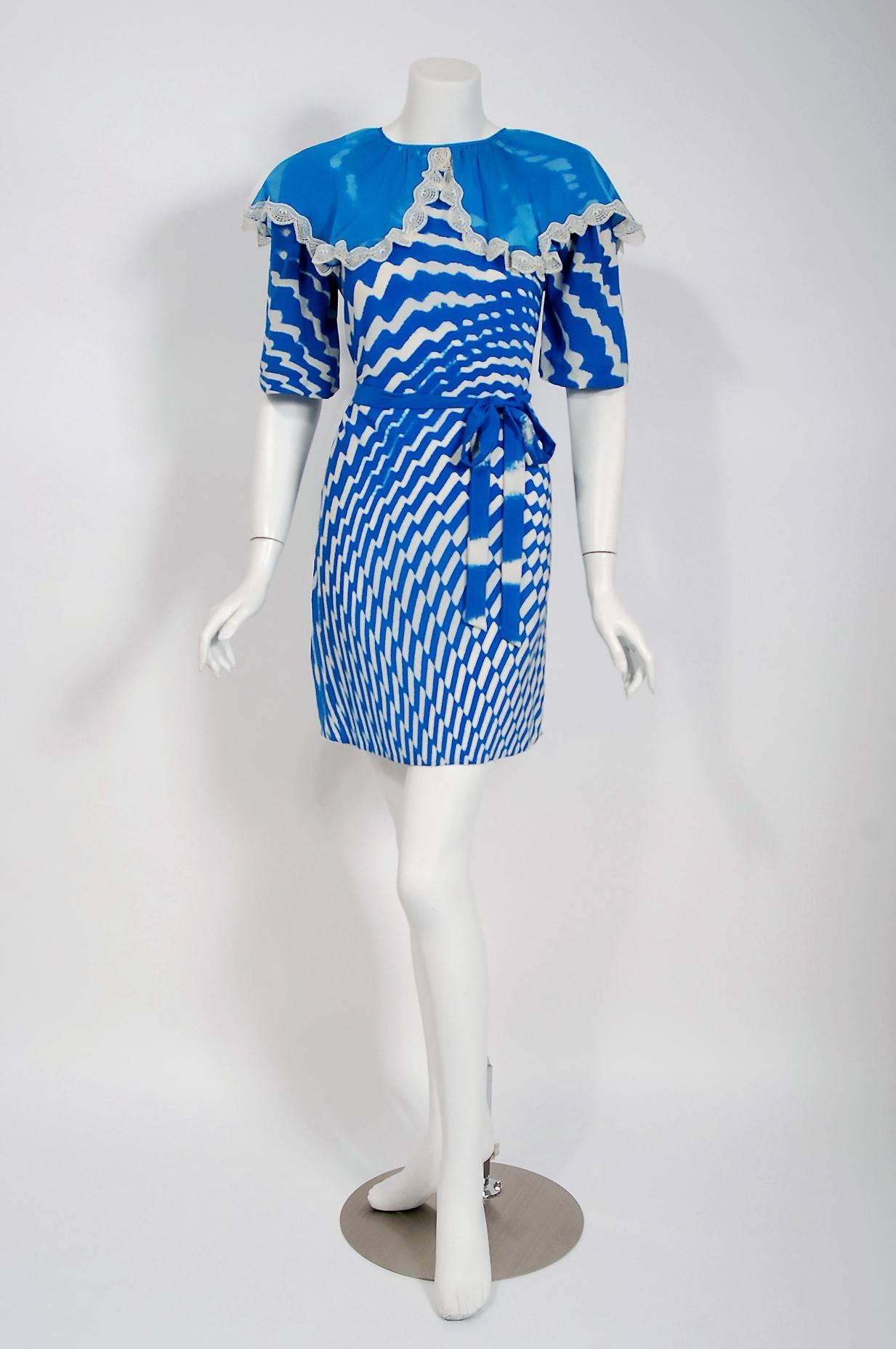Gorgeous 1970 Thea Porter Couture tunic dress fashioned in a stunning blue and white graphic op-art print silk. I love that oversize flouncy sheer silk-chiffon lace trimmed collar. The bodice is a clear nod to 1930's fashion. The flirty mini length