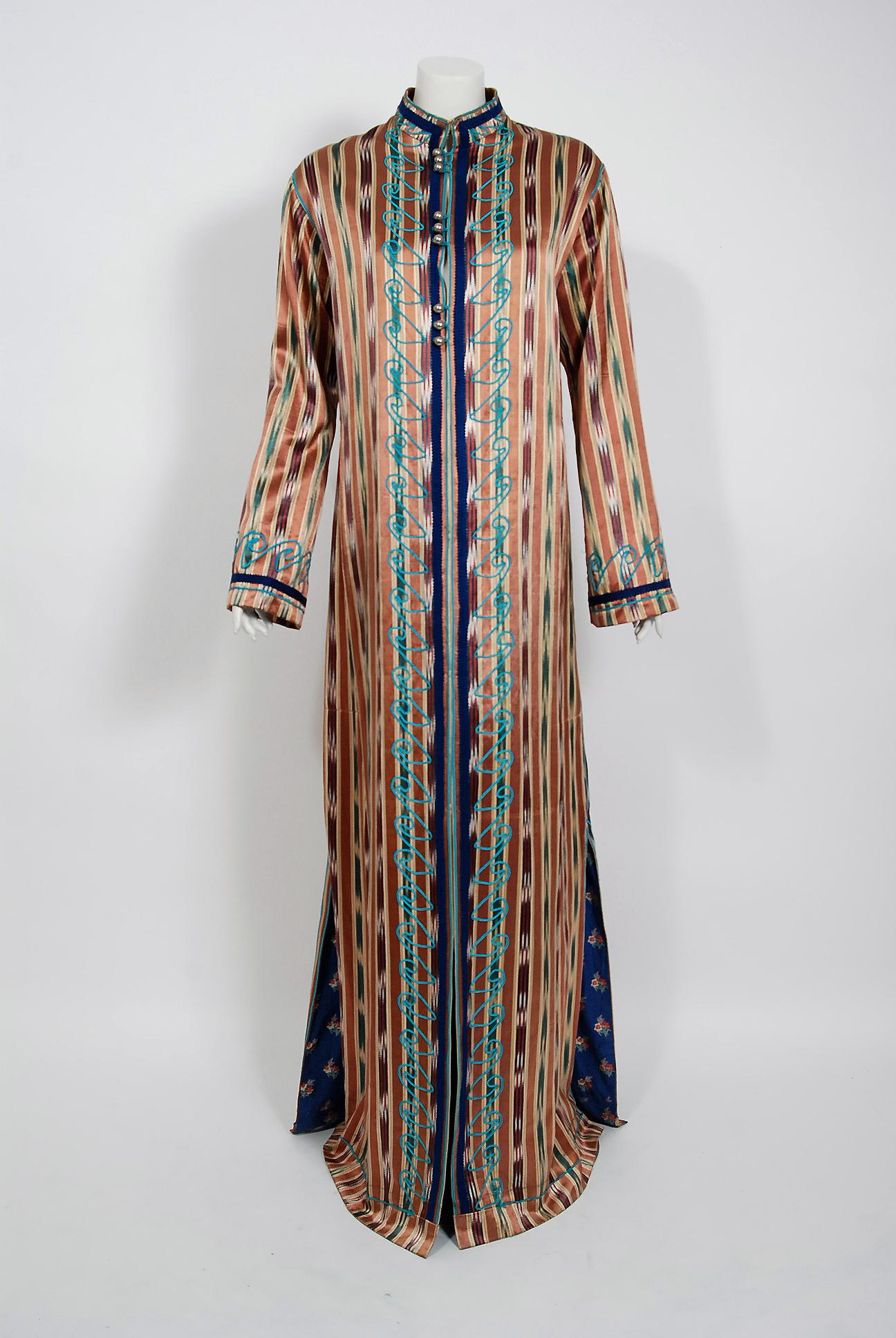 Gorgeous Thea Porter Couture full-length bohemian jacket dating back to the early 1970's. This rare garment is fashioned in the most beautiful mid-weight bronze and blue ikat-print silk; lined in a floral cotton which somehow works flawlessly. I