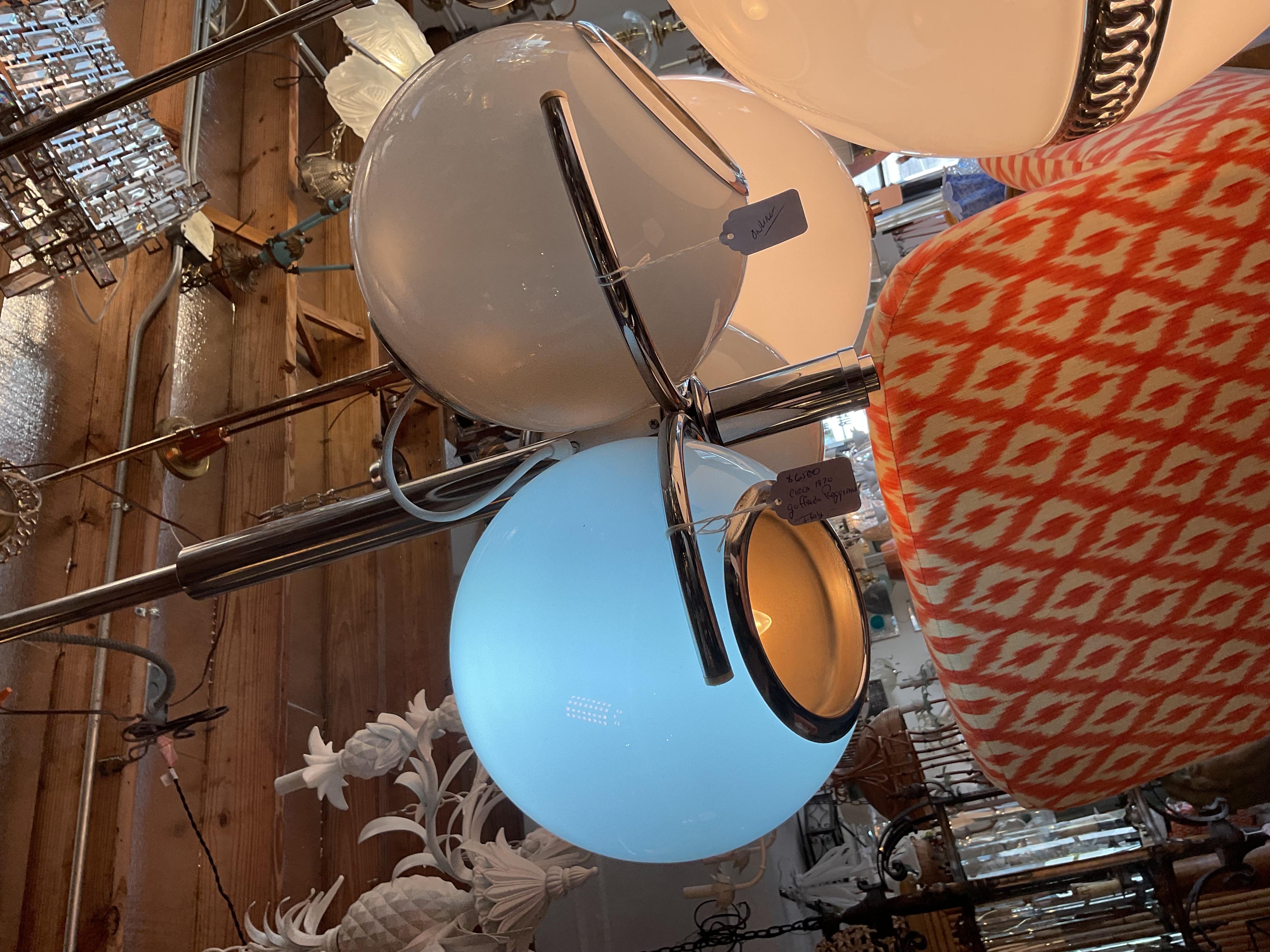 This gorgeous Quintessential Mid Century Modern Chandelier has white cased glass globes that light from inside as well as a directional spotlight within in each globe. They are moveable for directional light. Simple but dramatic deign. 
