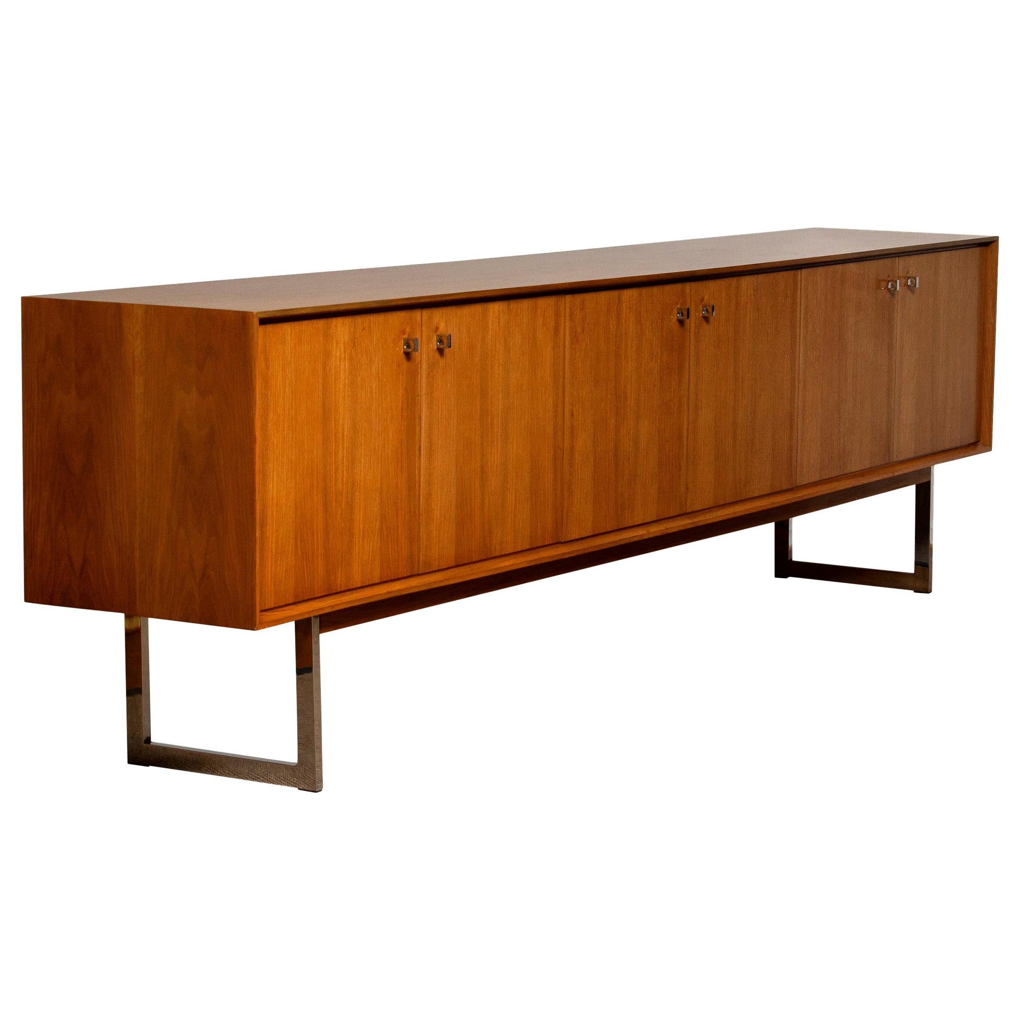Extreme beautiful and extra wide credenzas / sideboard, 118 inches, in walnut on chrome legs.
It's a great quality piece and the overall condition is very good!
 